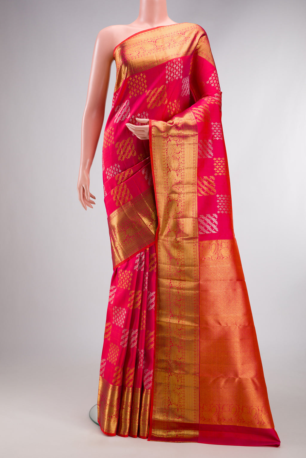 Pink Kanjivaram Silk Saree with Zari Brocade on the body and Zari Border.  displayed on a mannequin