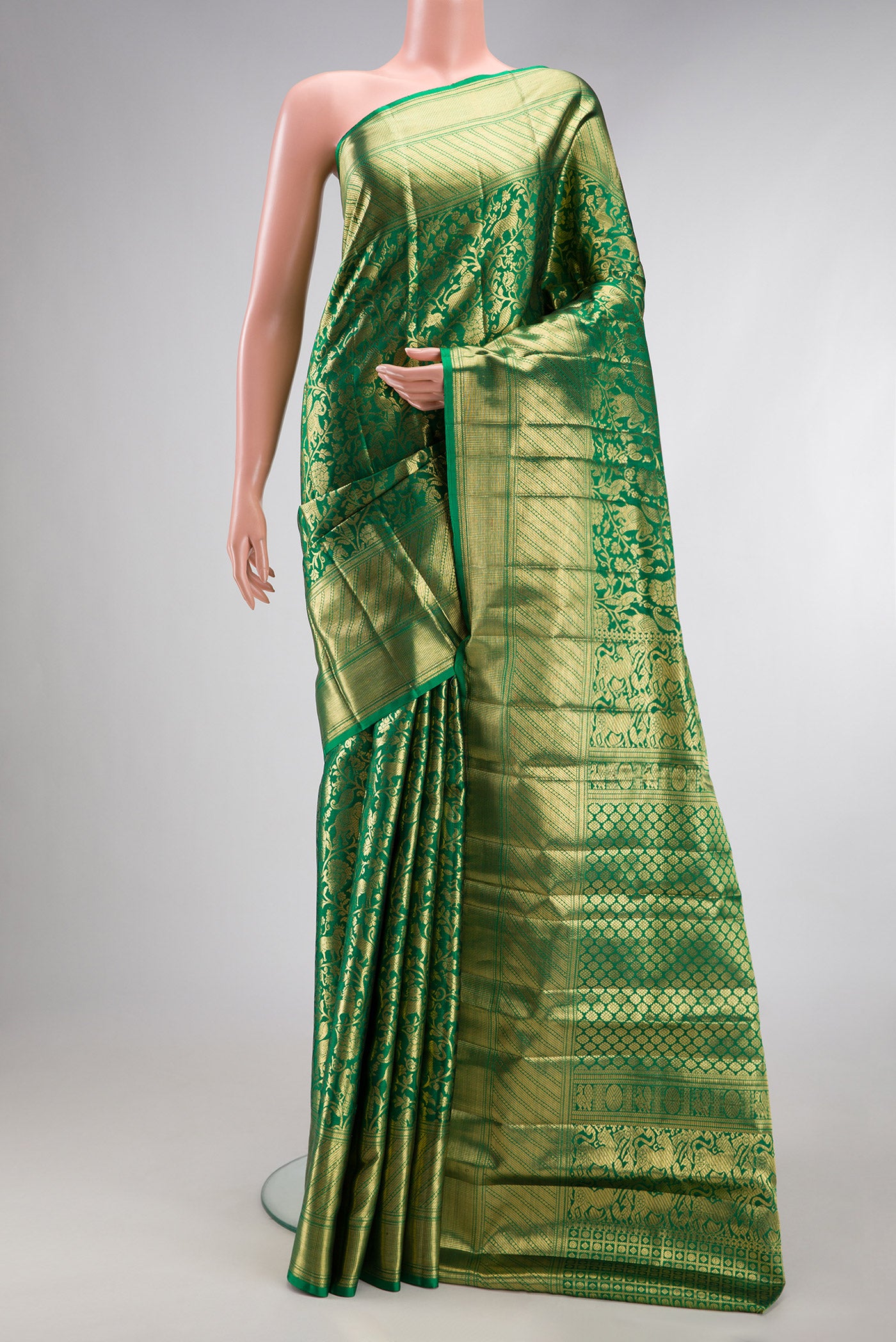 Green Kanjivaram Silk Saree with Zari Brocade on the body and Zari Border.  displayed on a mannequin