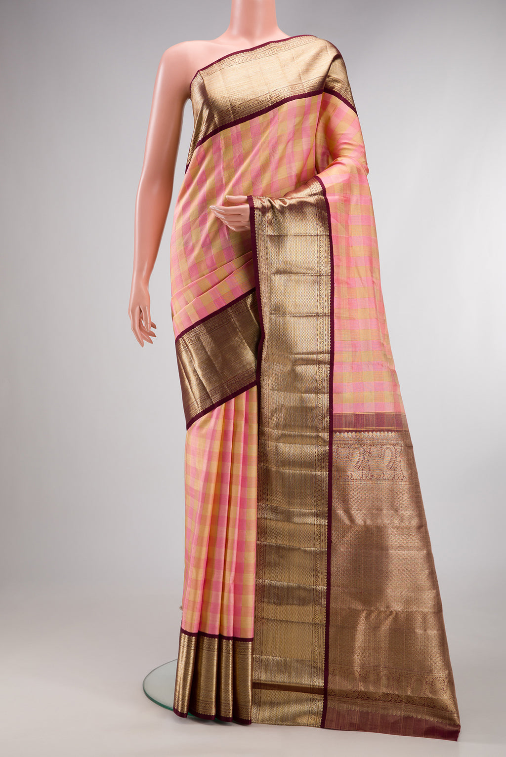 Pure Silk Rose pink Kanjivaram Tissue Saree with Checked design on the body and Zari Border.  displayed on a mannequin
