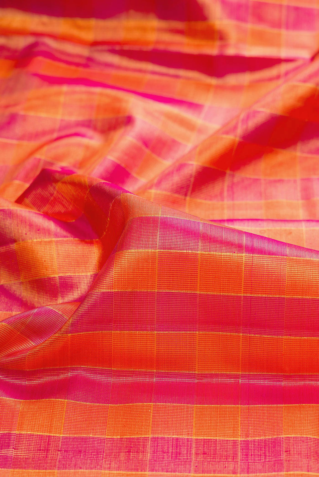 Close up of Multi Color Kanjivaram Tissue Saree with Checked design on the body and Zari Border.  displaying folds