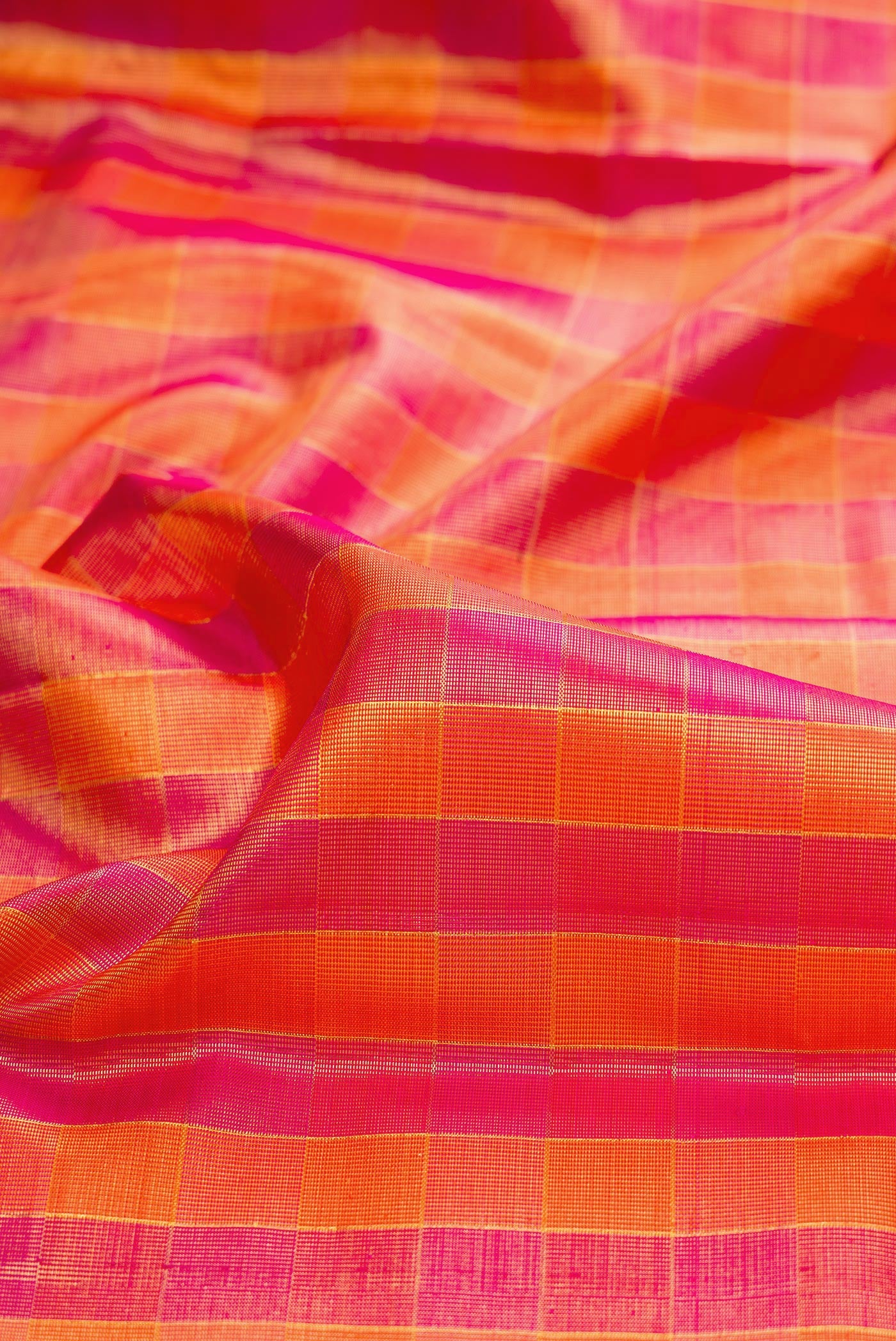Close up of Multi Color Kanjivaram Tissue Saree with Checked design on the body and Zari Border.  displaying folds