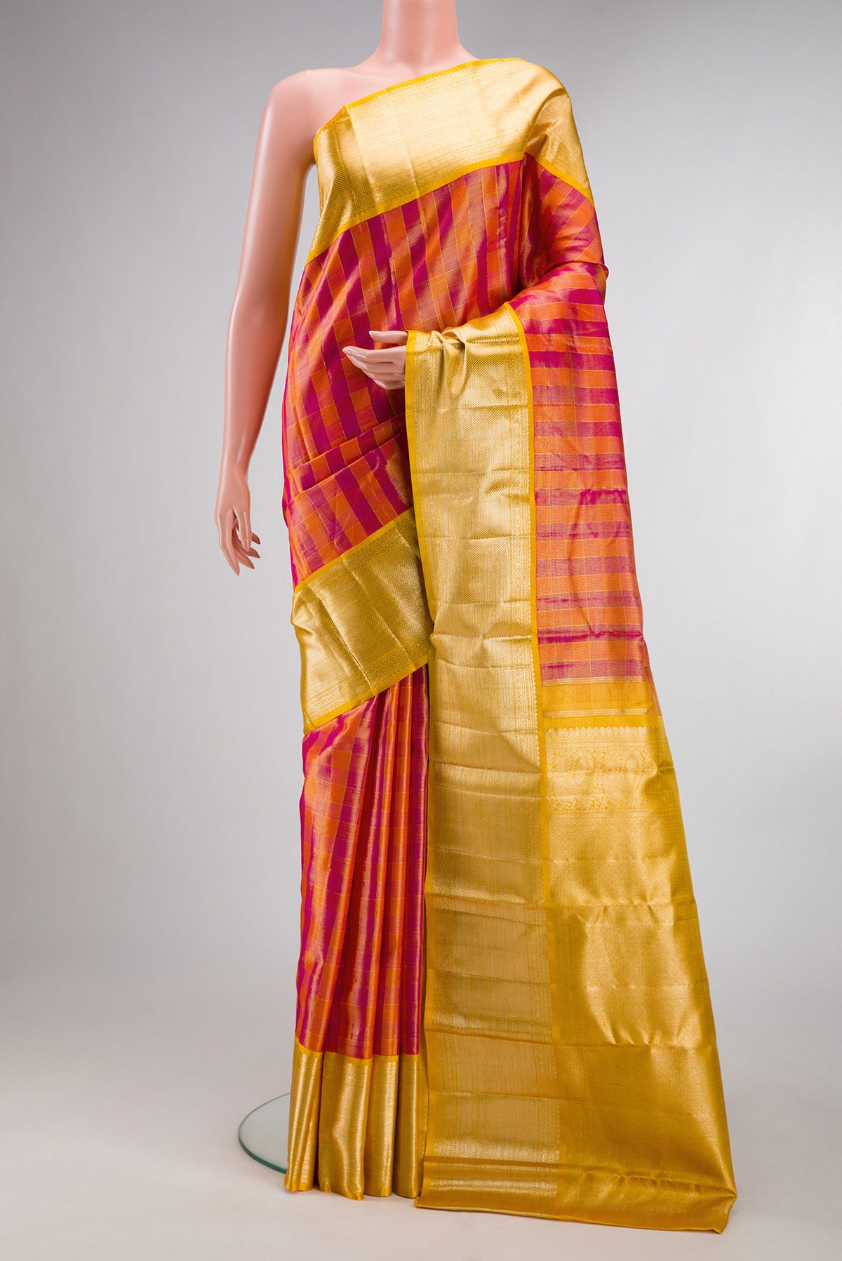 Multi Color Kanjivaram Tissue Saree with Checked design on the body and Zari Border.  displayed on a mannequin