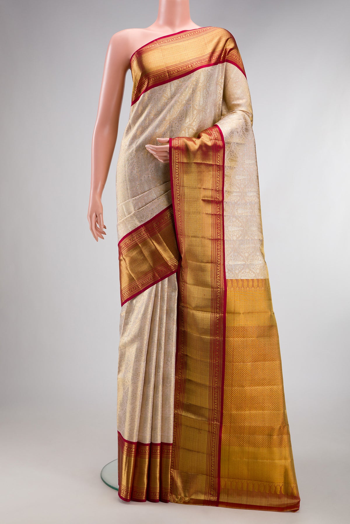 Golden Peach Kanjivaram Tissue Silk Saree with Zari Brocade on the body and Zari Border.  displayed on a mannequin