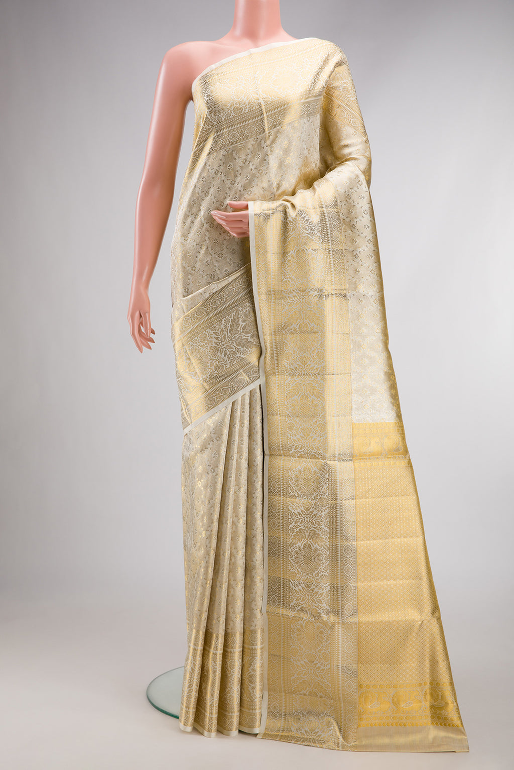Off White Dual Tone Kanjivaram Tissue Silk Saree with Zari Brocade on the body and Fancy Border.  displayed on a mannequin