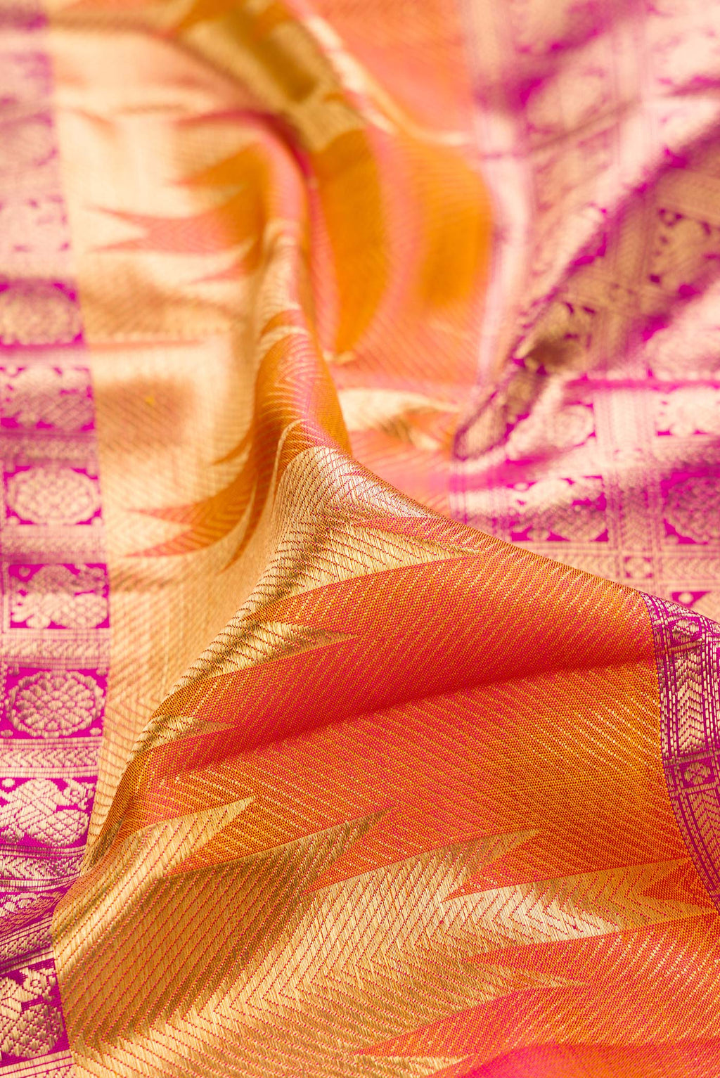 Close up of Pure Silk Multi Color Kanjivaram Saree with Zari Brocade on the body and Temple Border.  displaying folds