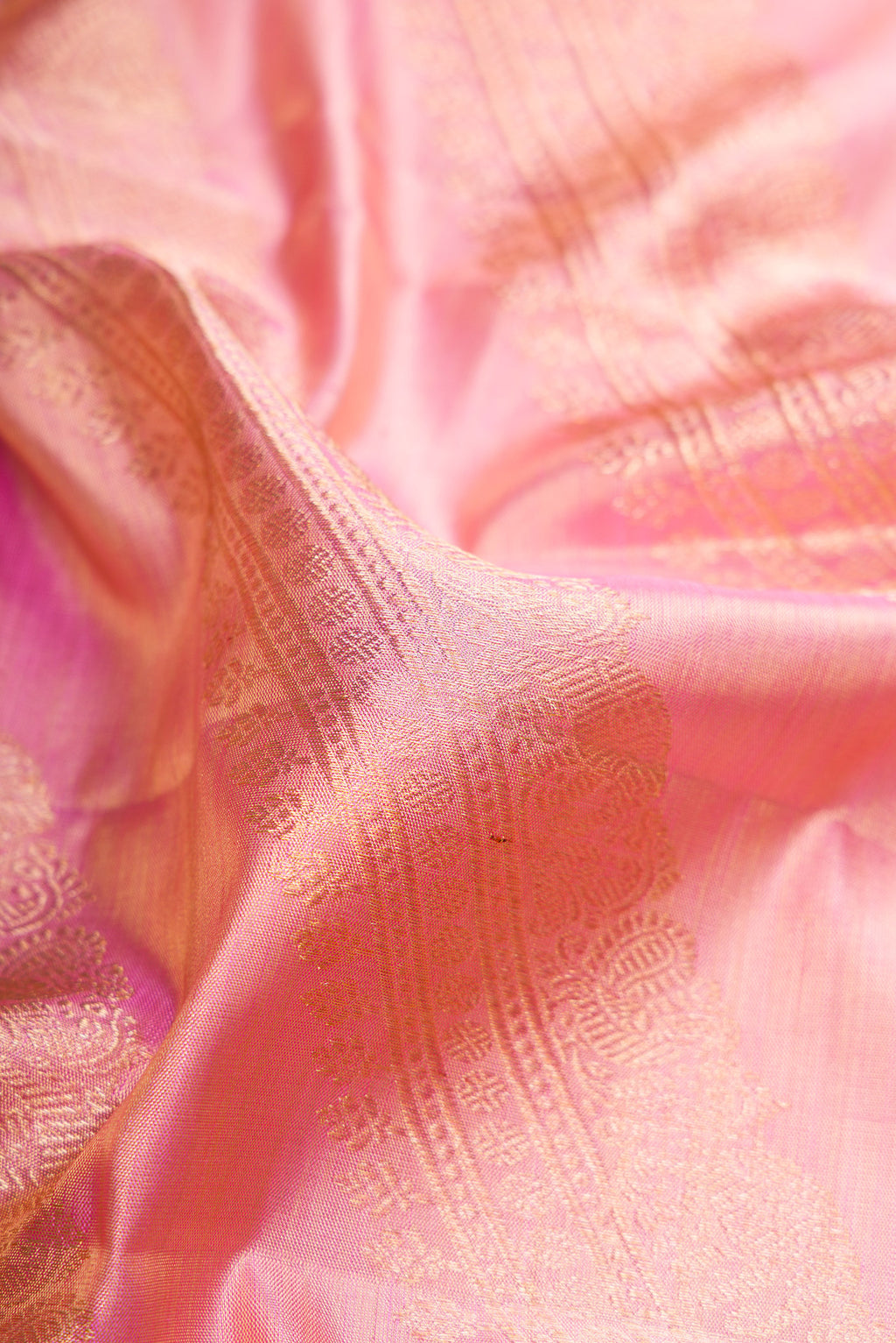 Close up of Rose pink Dual Tone Kanjivaram Tissue Silk Saree with Zari Brocade on the body and Zari Border.  displaying folds