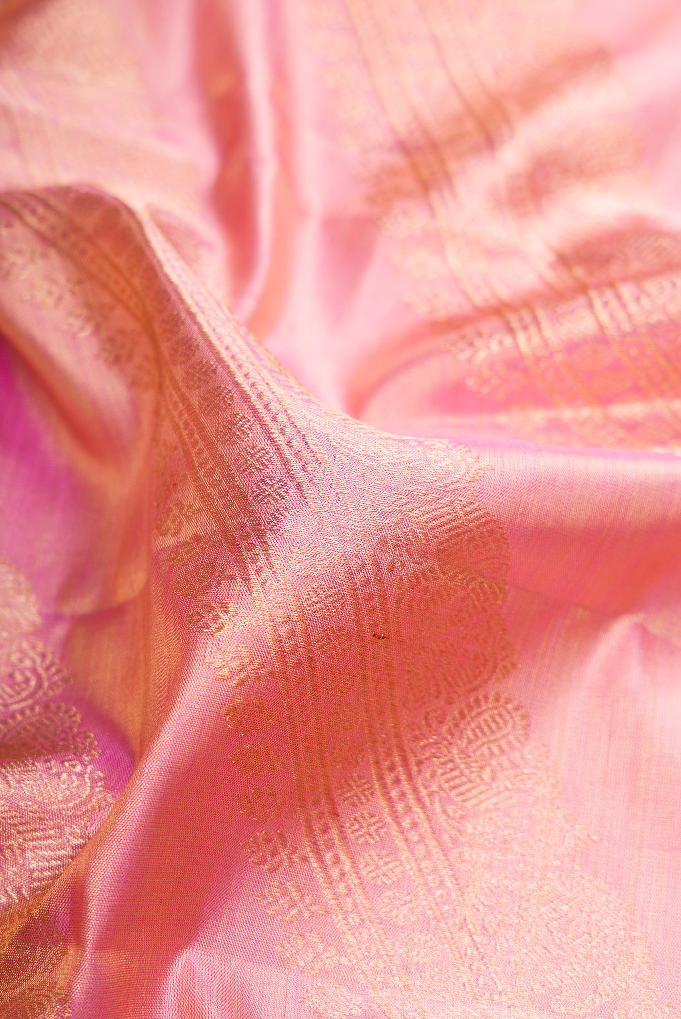 Close up of Rose pink Dual Tone Kanjivaram Tissue Silk Saree with Zari Brocade on the body and Zari Border.  displaying folds