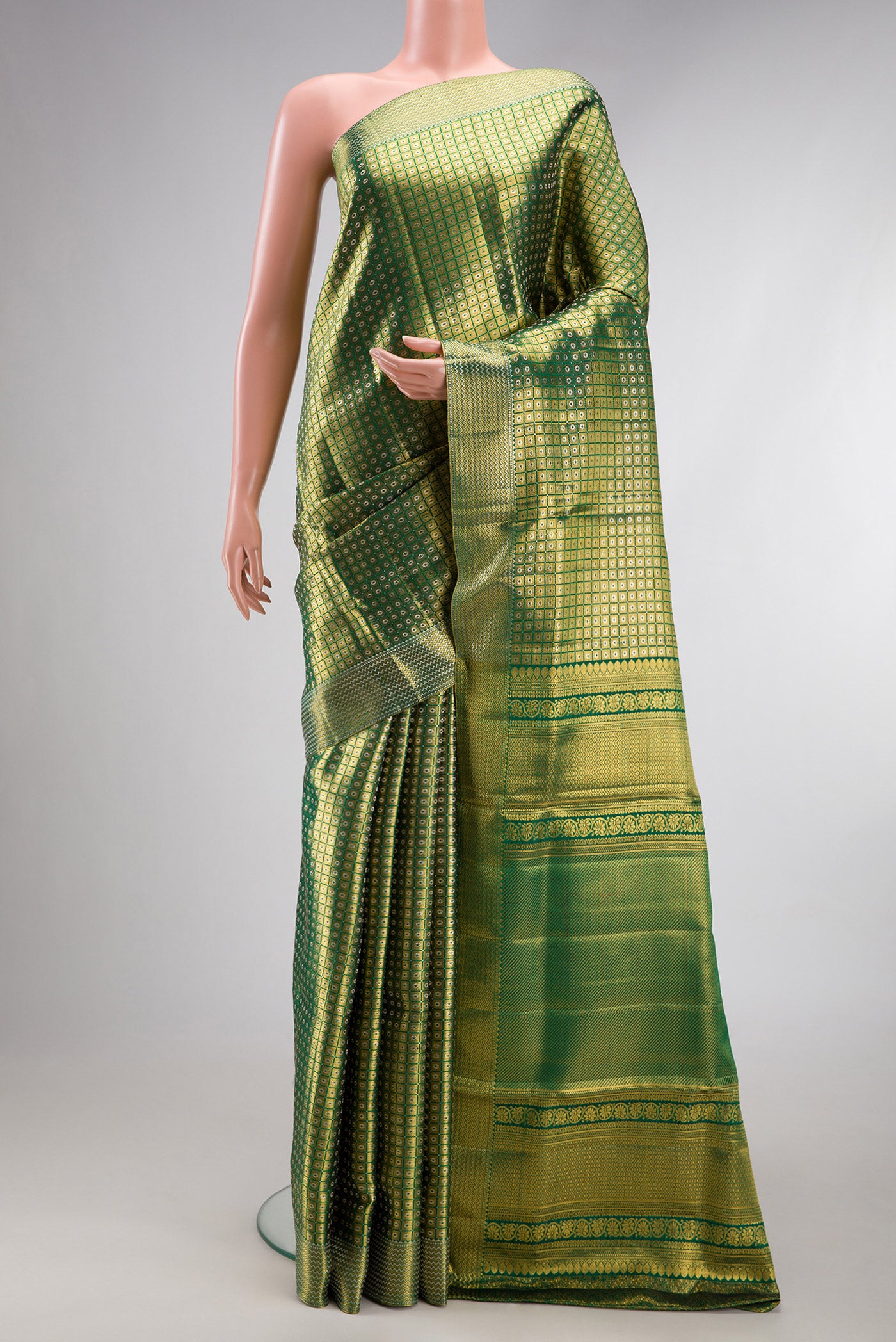 Green Kanjivaram Silk Saree with Zari Brocade on the body and Zari Border.  displayed on a mannequin