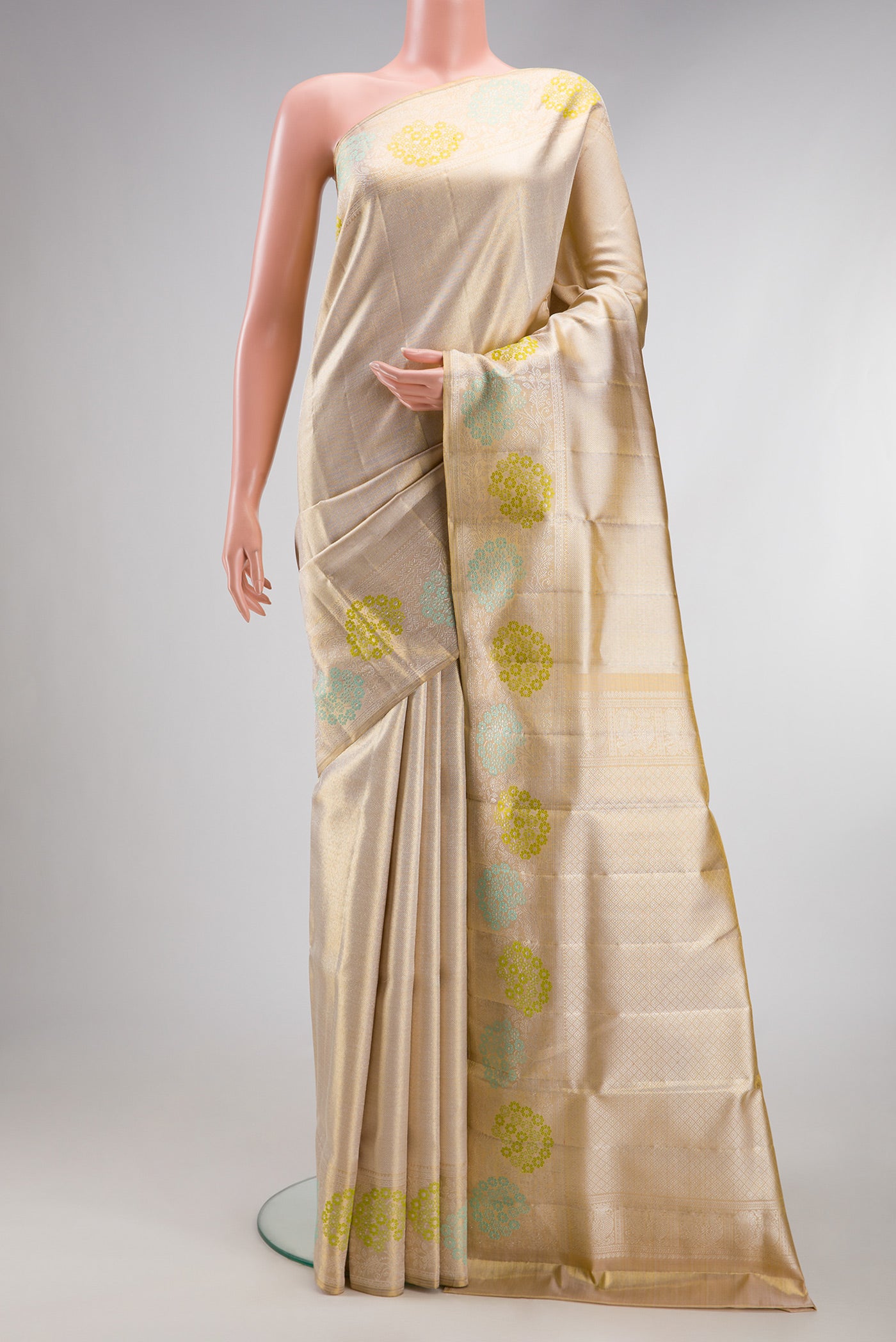 Golden Peach Dual Tone Kanjivaram Tissue Silk Saree with Zari Brocade on the body and Fancy Border.  displayed on a mannequin
