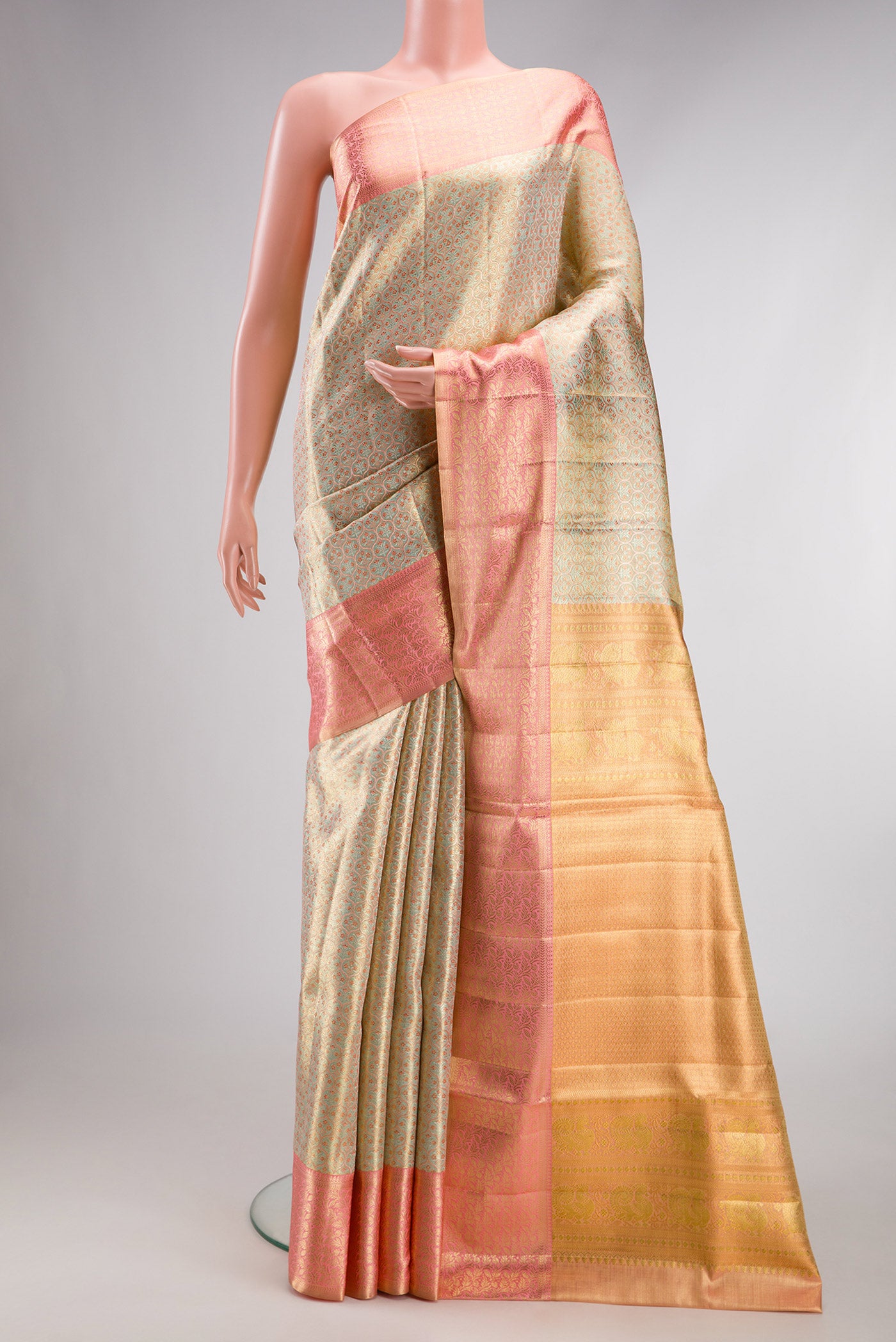 Pista Green Dual Tone Kanjivaram Tissue Silk Saree with Zari Brocade on the body and Fancy Border.  displayed on a mannequin