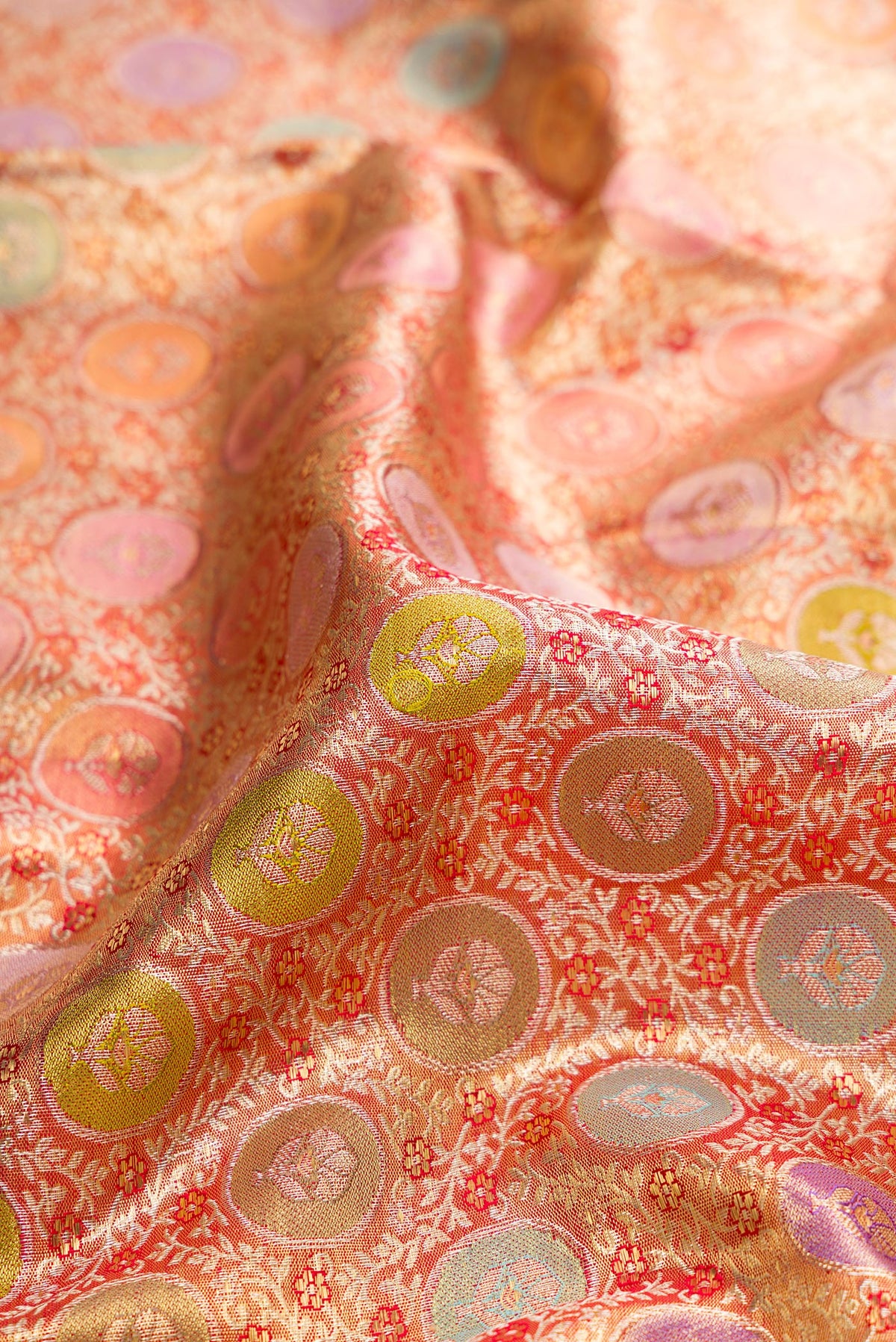 Close up of Pure Silk Golden Peach Dual Tone Kanjivaram Tissue Saree with Zari Brocade on the body and Zari Border.  displaying folds