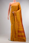 Pure Silk Mustard Kanchipuram Saree with Checked design on the body and Plain Border.  displayed on a mannequin