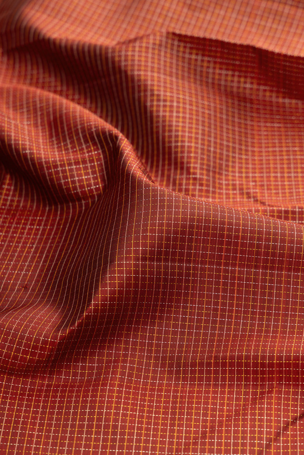 Close up of Maroon Kanchipuram Silk Saree with Stripes on the body and Plain Border.  displaying folds