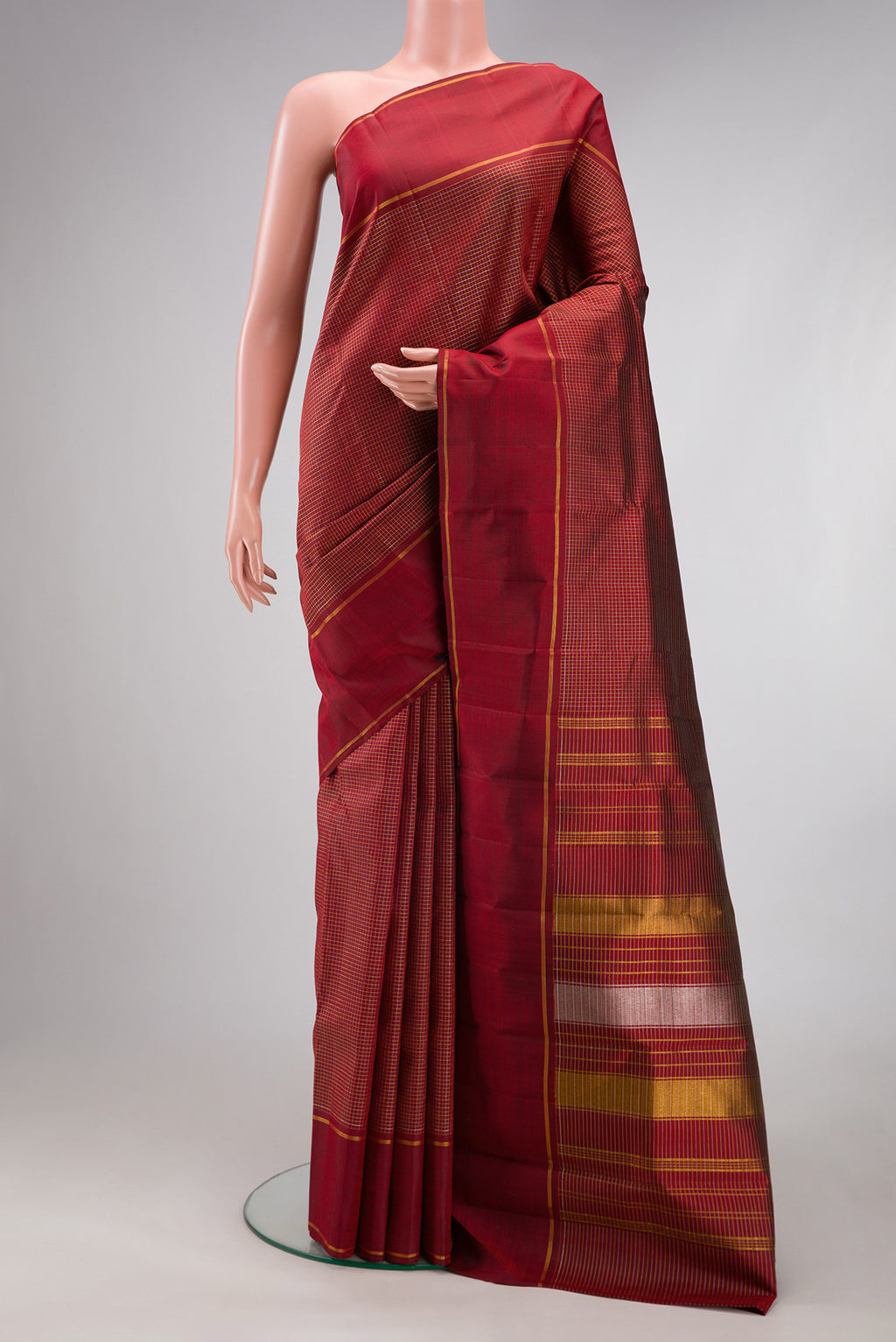 Maroon Kanchipuram Silk Saree with Stripes on the body and Plain Border.  displayed on a mannequin