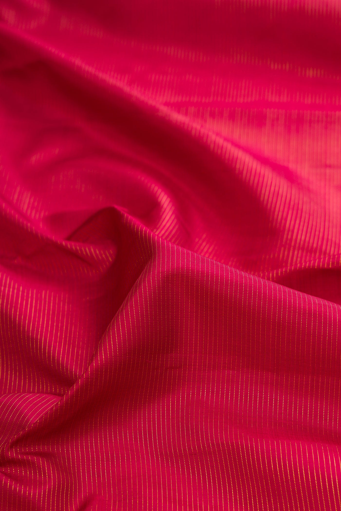 Close up of Pure Silk Maroon Kanchipuram Saree with Stripes on the body and Zari Border.  displaying folds