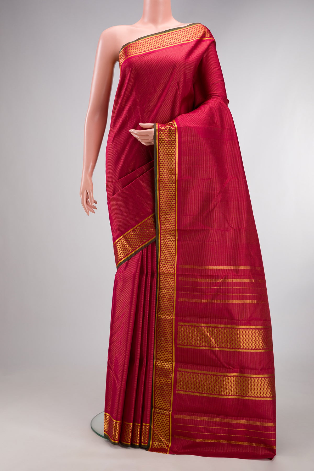 Pure Silk Maroon Kanchipuram Saree with Stripes on the body and Zari Border.  displayed on a mannequin