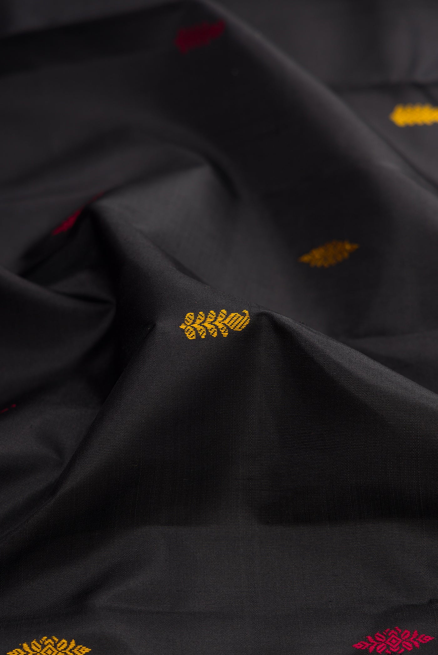 Close up of Black Kanjivaram Silk Saree with Thread Butta on the body and Ganga Jamuna Border.  displaying folds