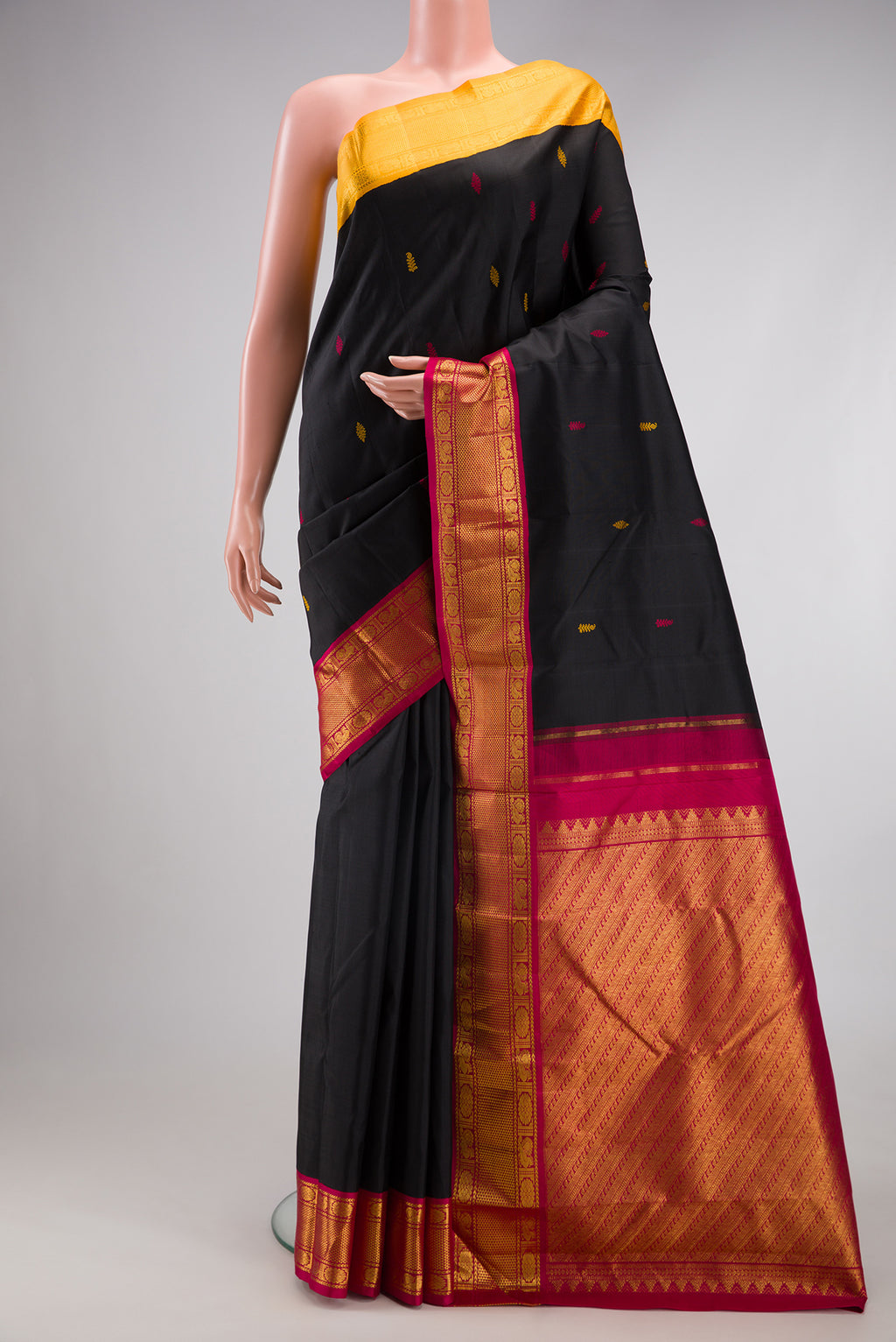 Black Kanjivaram Silk Saree with Thread Butta on the body and Ganga Jamuna Border.  displayed on a mannequin