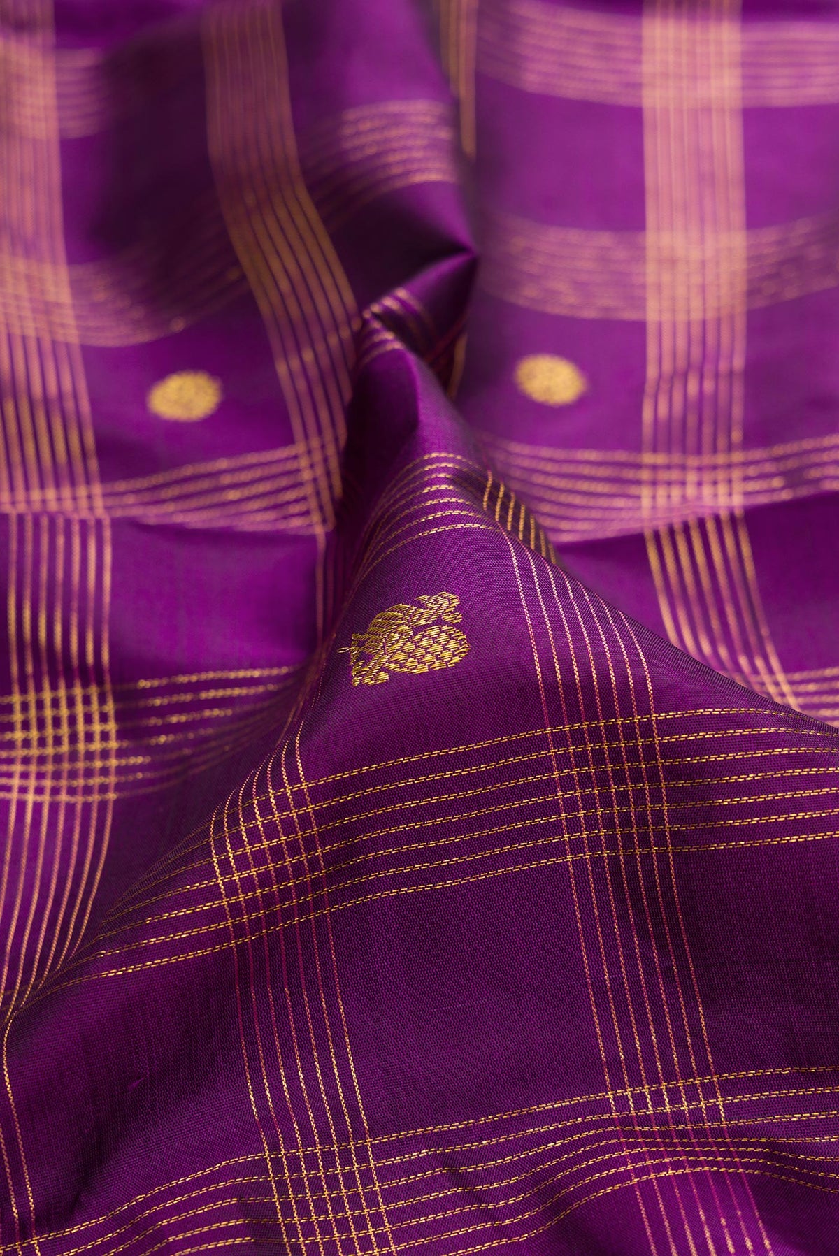Close up of Pure Silk Purple Kanjivaram Saree with Checked design on the body and Zari Border.  displaying folds