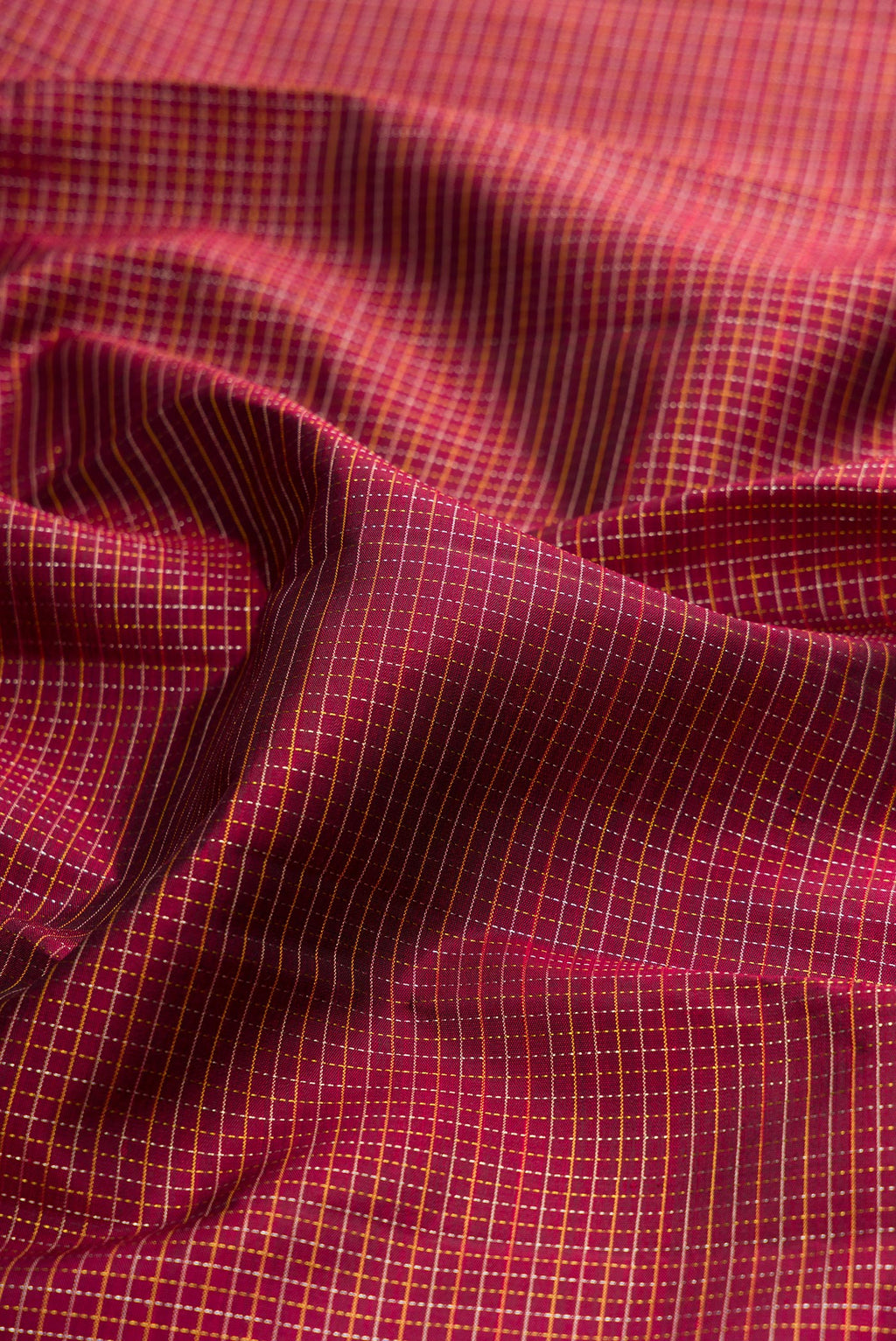 Close up of Maroon Kanchipuram Silk Saree with Stripes on the body and Zari Border.  displaying folds