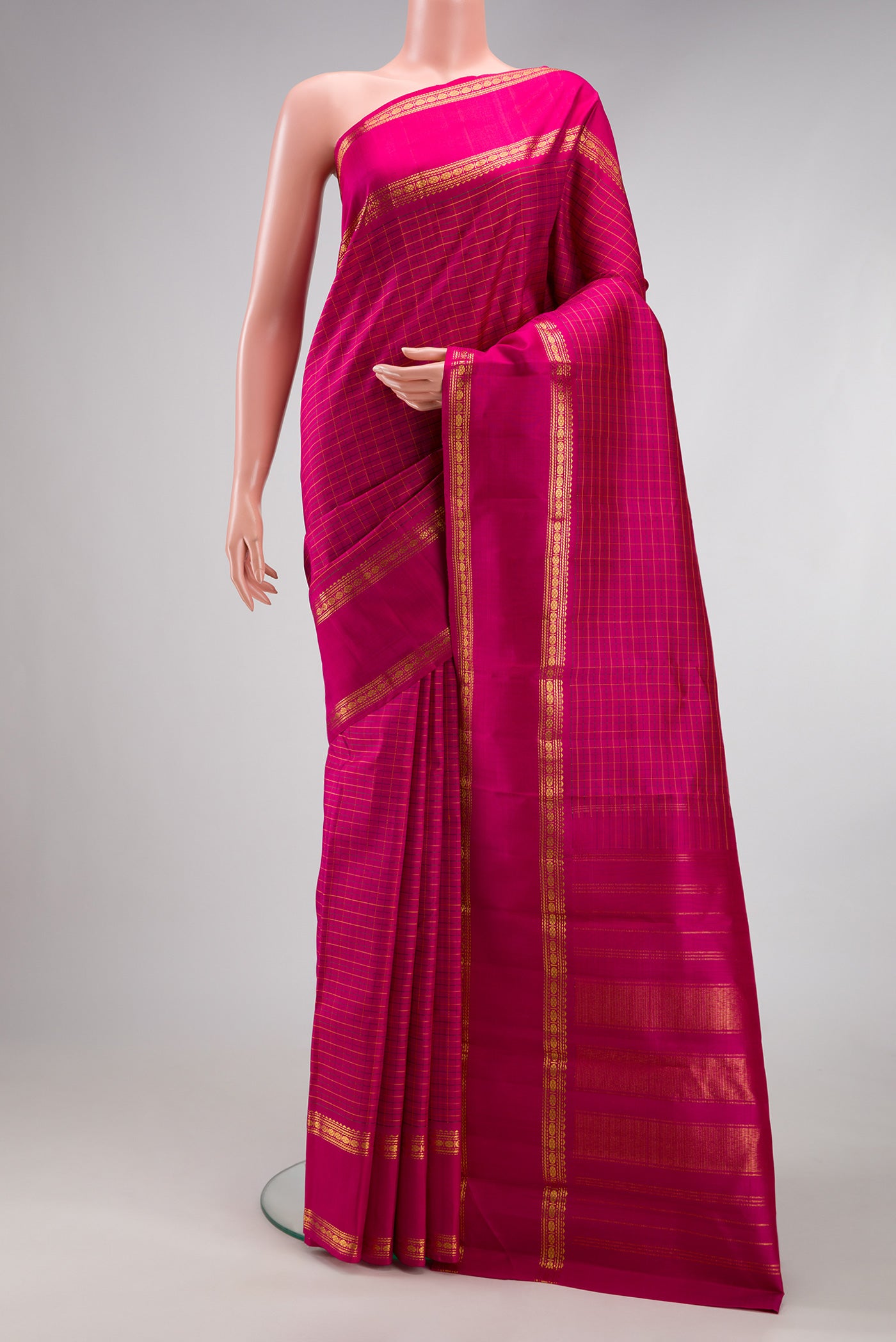 Magenta Kanchipuram Silk Saree with Checked design on the body and Zari Border.  displayed on a mannequin