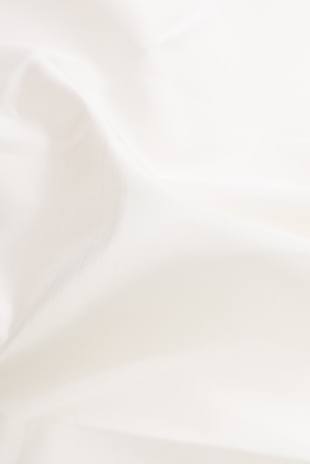 Close up of White Kanchipuram Silk Saree with Plain Body and Temple Border.  displaying folds