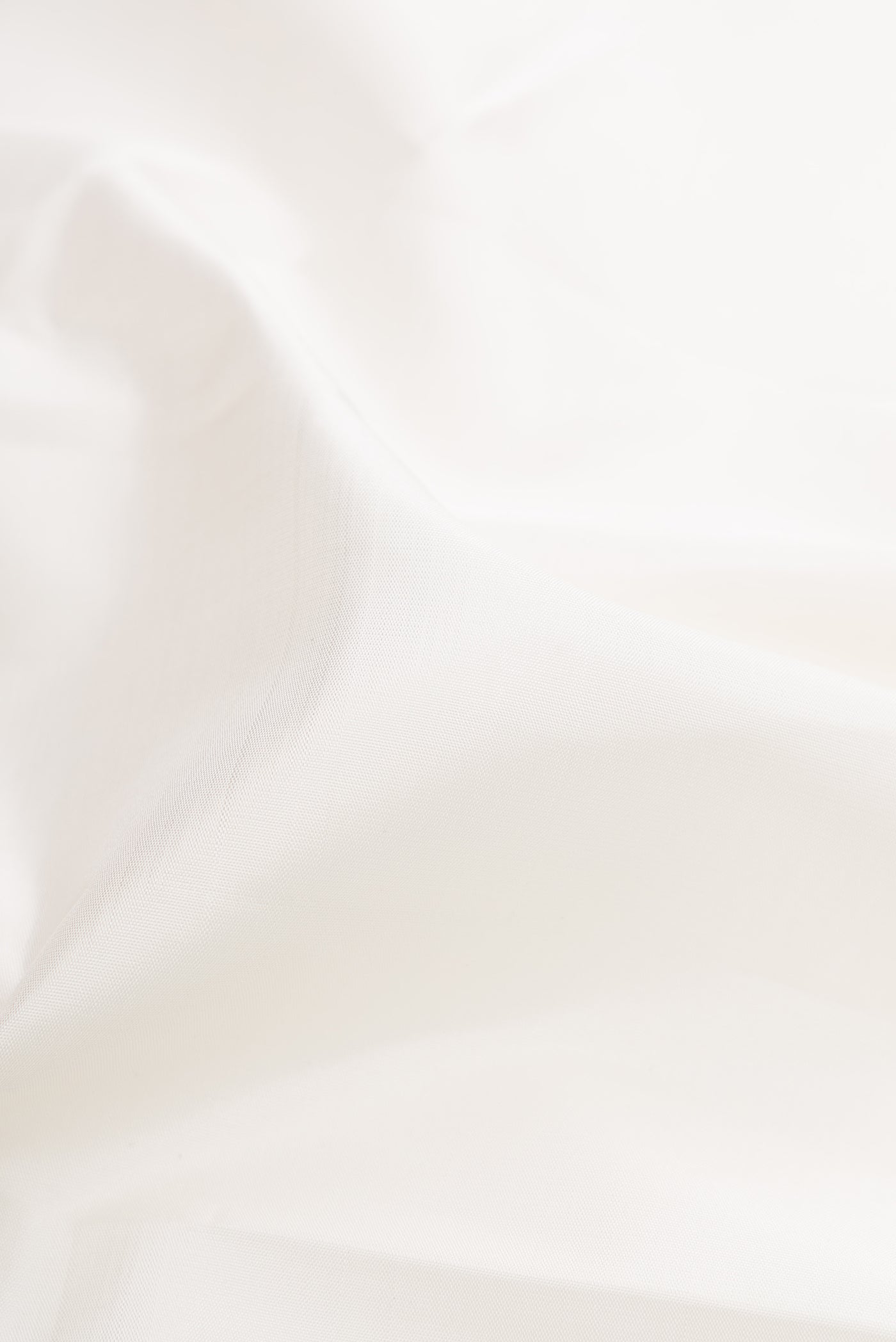 Close up of White Kanchipuram Silk Saree with Plain Body and Temple Border.  displaying folds
