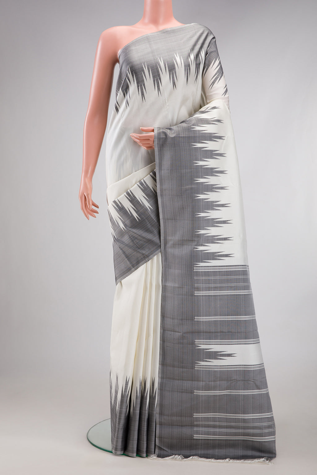 White Kanchipuram Silk Saree with Plain Body and Temple Border.  displayed on a mannequin