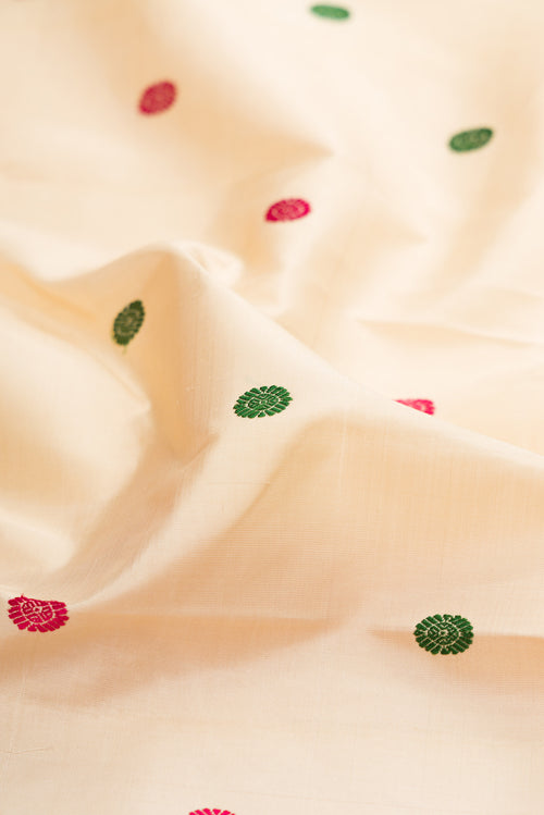 Close up of Beige Kanjivaram Silk Saree with Thread Butta on the body and Zari Border.  displaying folds