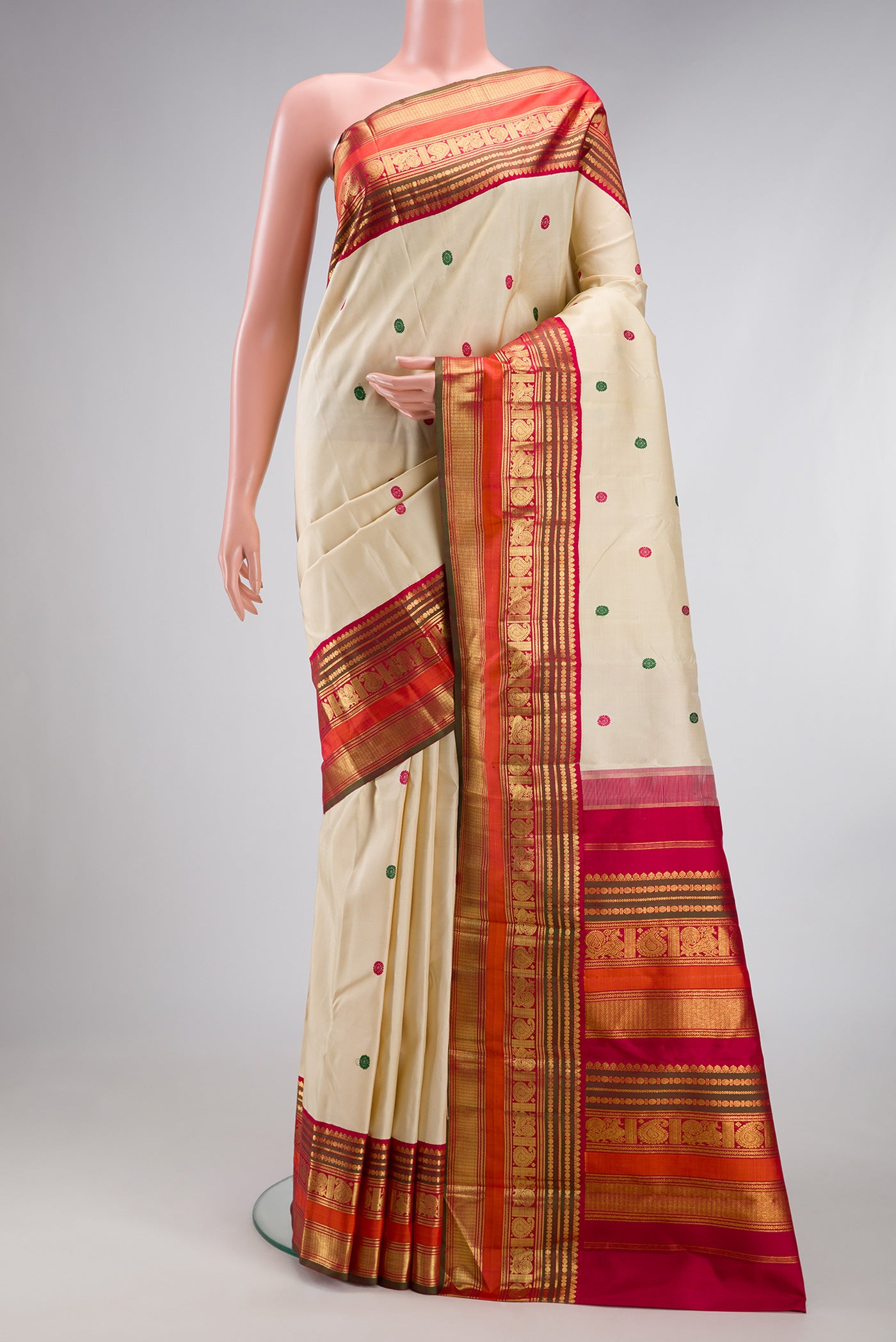 Beige Kanjivaram Silk Saree with Thread Butta on the body and Zari Border.  displayed on a mannequin