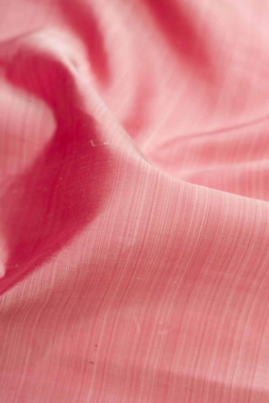 Close up of Rose Gold Kanchipuram Silk Saree with Plain Body and Temple Border.  displaying folds