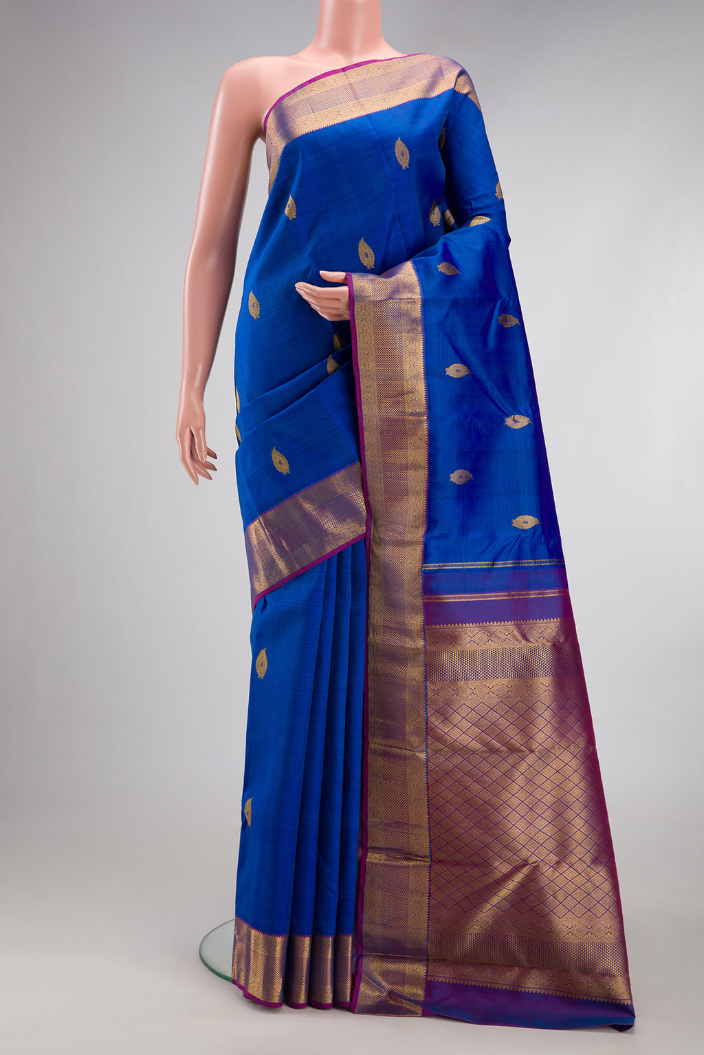 Royal Blue Kanjivaram Silk Saree with Zari Butta on the body and Zari Border.  displayed on a mannequin