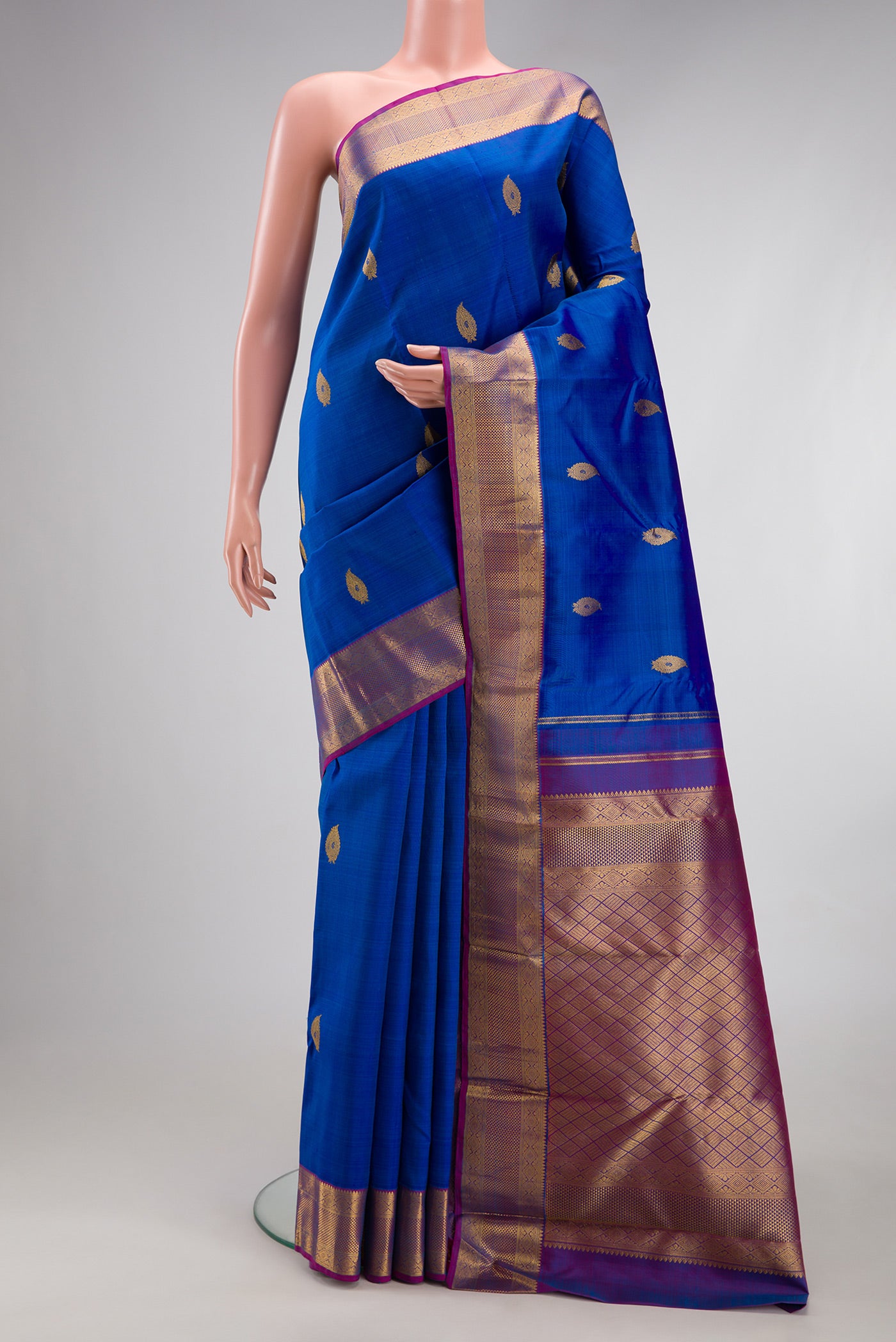Royal Blue Kanjivaram Silk Saree with Zari Butta on the body and Zari Border.  displayed on a mannequin