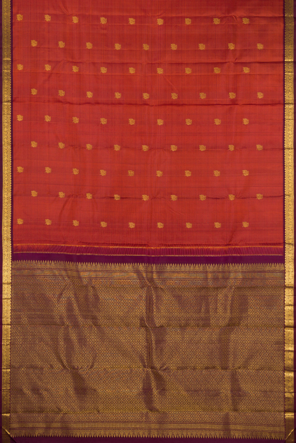 Flat view of Brick Orange Dual Tone Kanchipuram Silk Saree with Zari Butta on the body and Zari Border. 