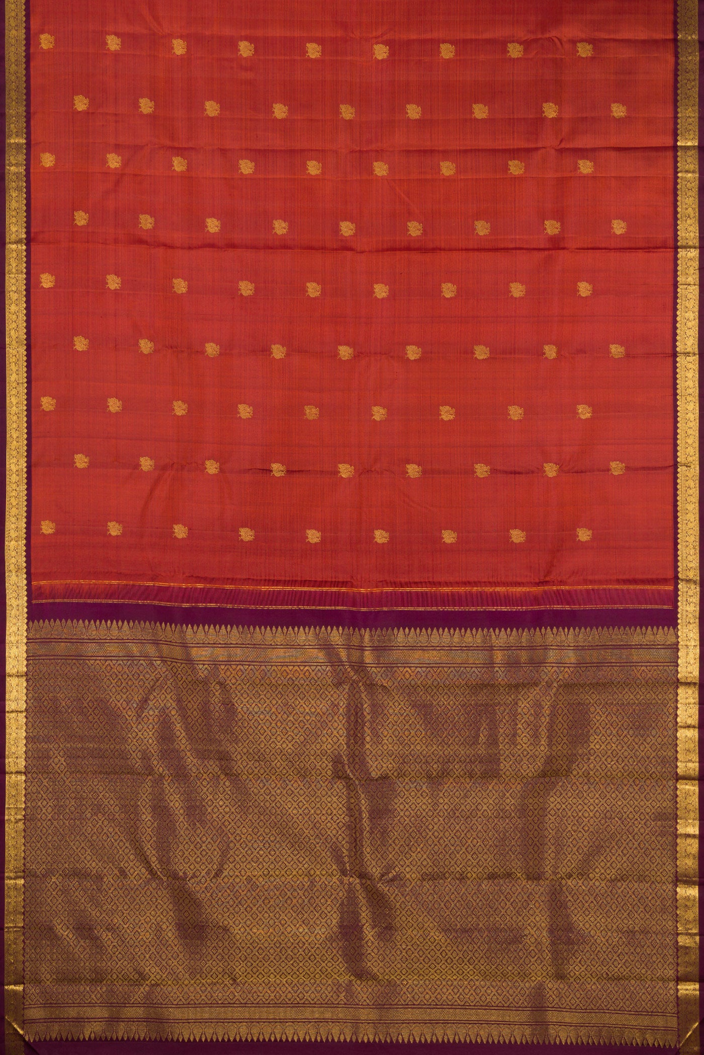 Flat view of Brick Orange Dual Tone Kanchipuram Silk Saree with Zari Butta on the body and Zari Border. 