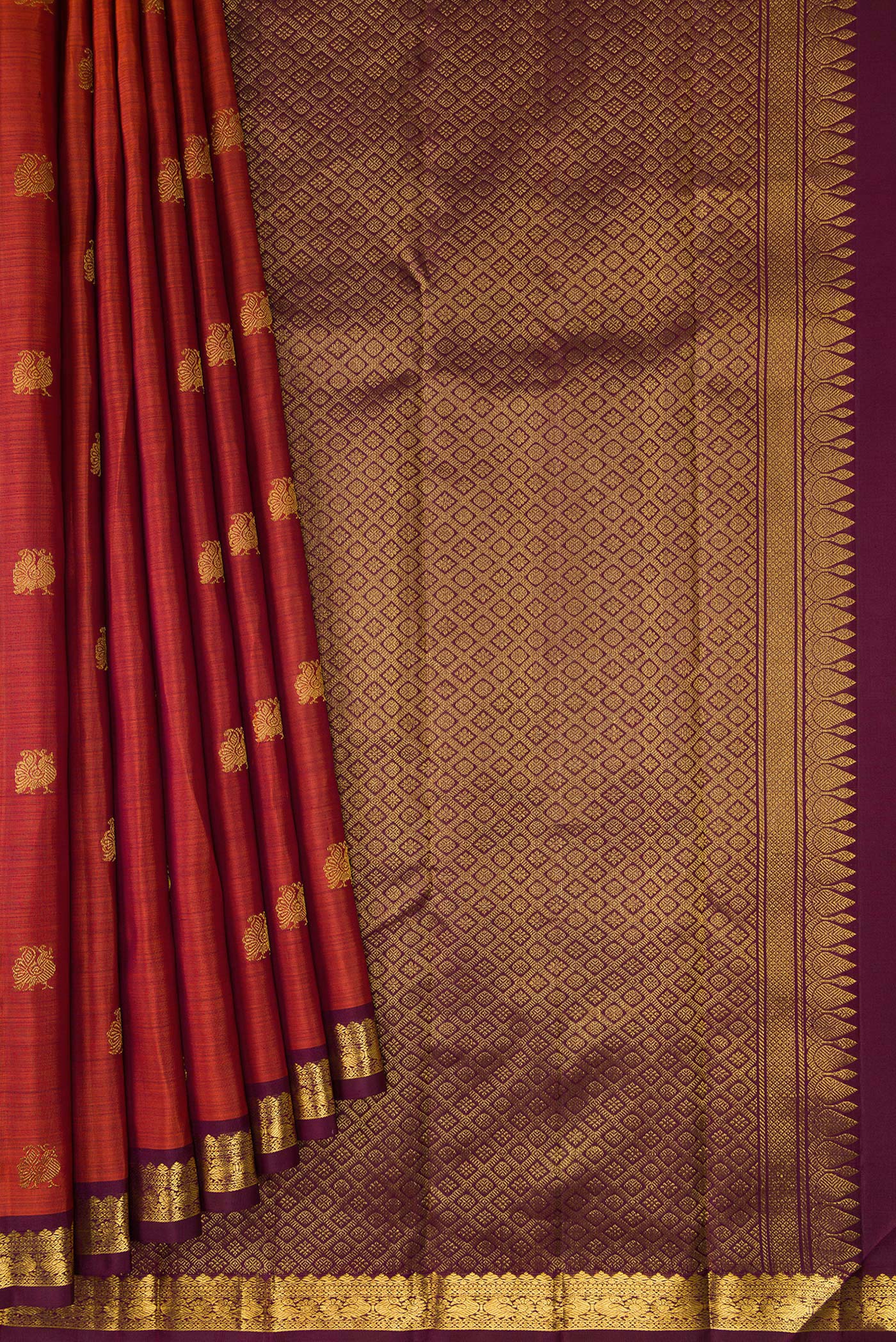 Pleats and pallu of Brick Orange Dual Tone Kanchipuram Silk Saree with Zari Butta on the body and Zari Border. 
