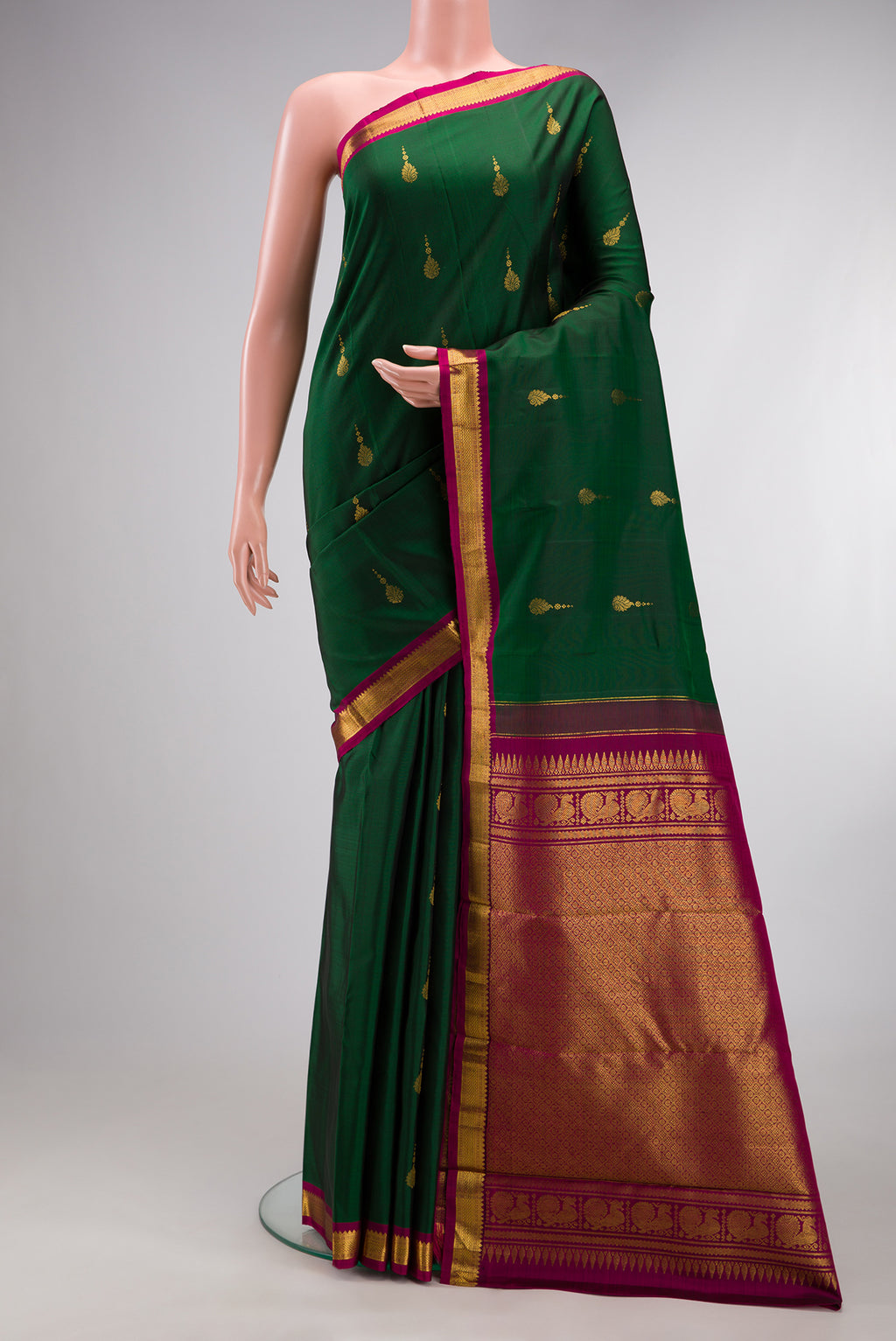 Pure Silk Bottle Green Kanchipuram Saree with Zari Butta on the body and Zari Border.  displayed on a mannequin