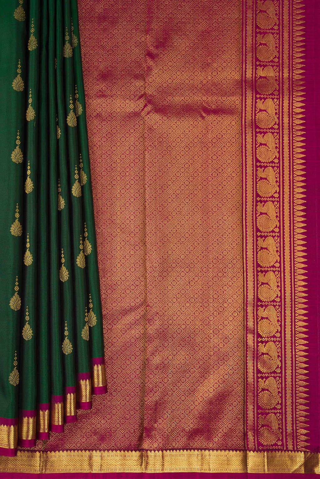 Pleats and pallu of Pure Silk Bottle Green Kanchipuram Saree with Zari Butta on the body and Zari Border. 