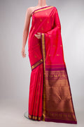 Pure Silk Coral Dual Tone Kanchipuram Saree with Zari Butta on the body and Zari Border.  displayed on a mannequin