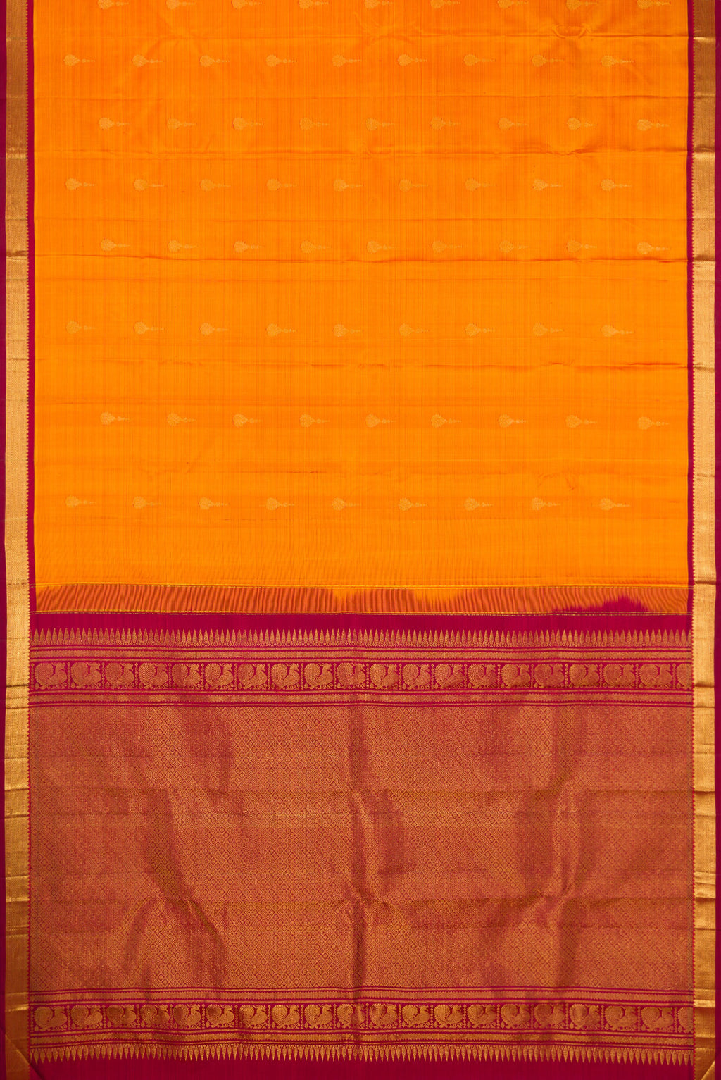 Flat view of Mustard Kanchipuram Silk Saree with Zari Butta on the body and Zari Border. 