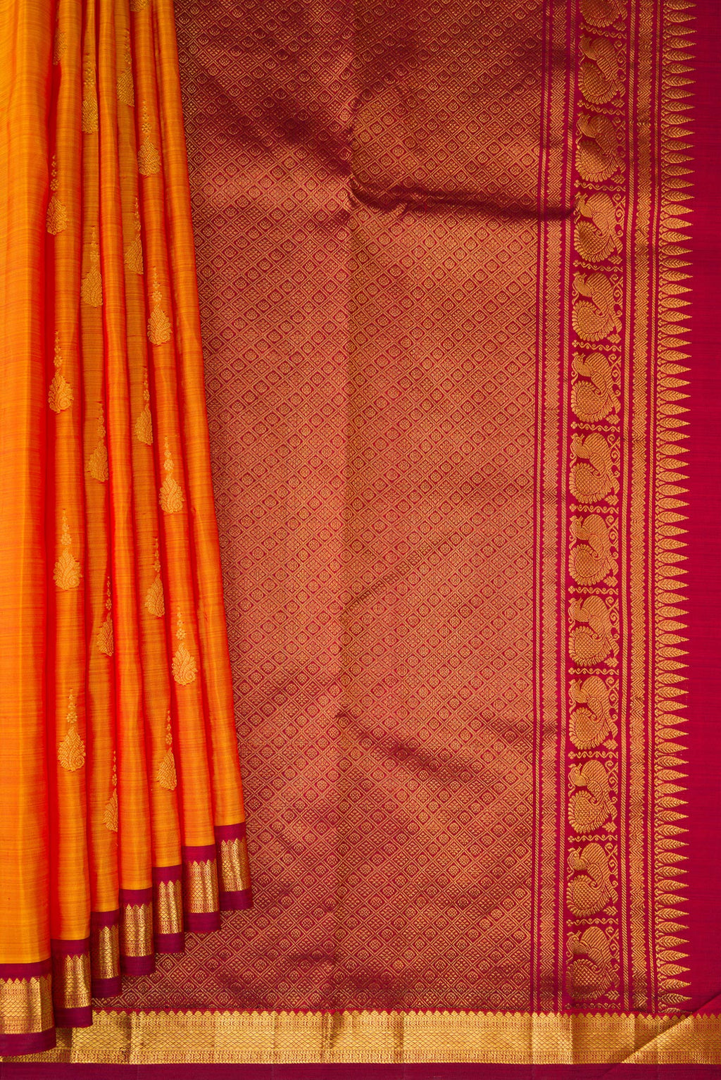 Pleats and pallu of Mustard Kanchipuram Silk Saree with Zari Butta on the body and Zari Border. 
