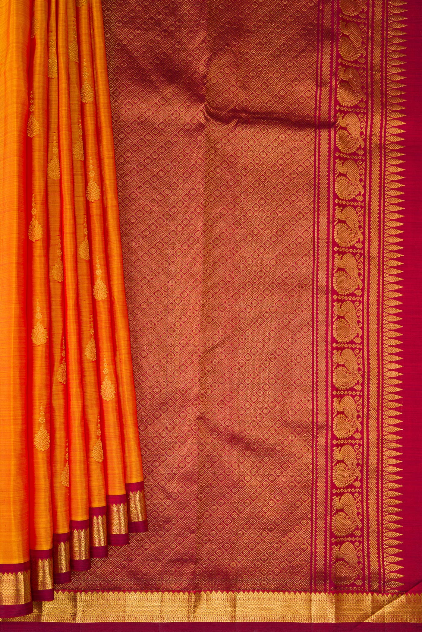Pleats and pallu of Mustard Kanchipuram Silk Saree with Zari Butta on the body and Zari Border. 