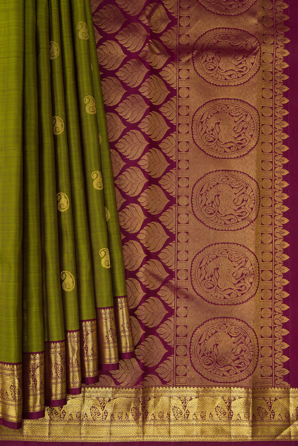 Pleats and pallu of Mehandi Green Kanchipuram Silk Saree with Zari Butta on the body and Zari Border. 