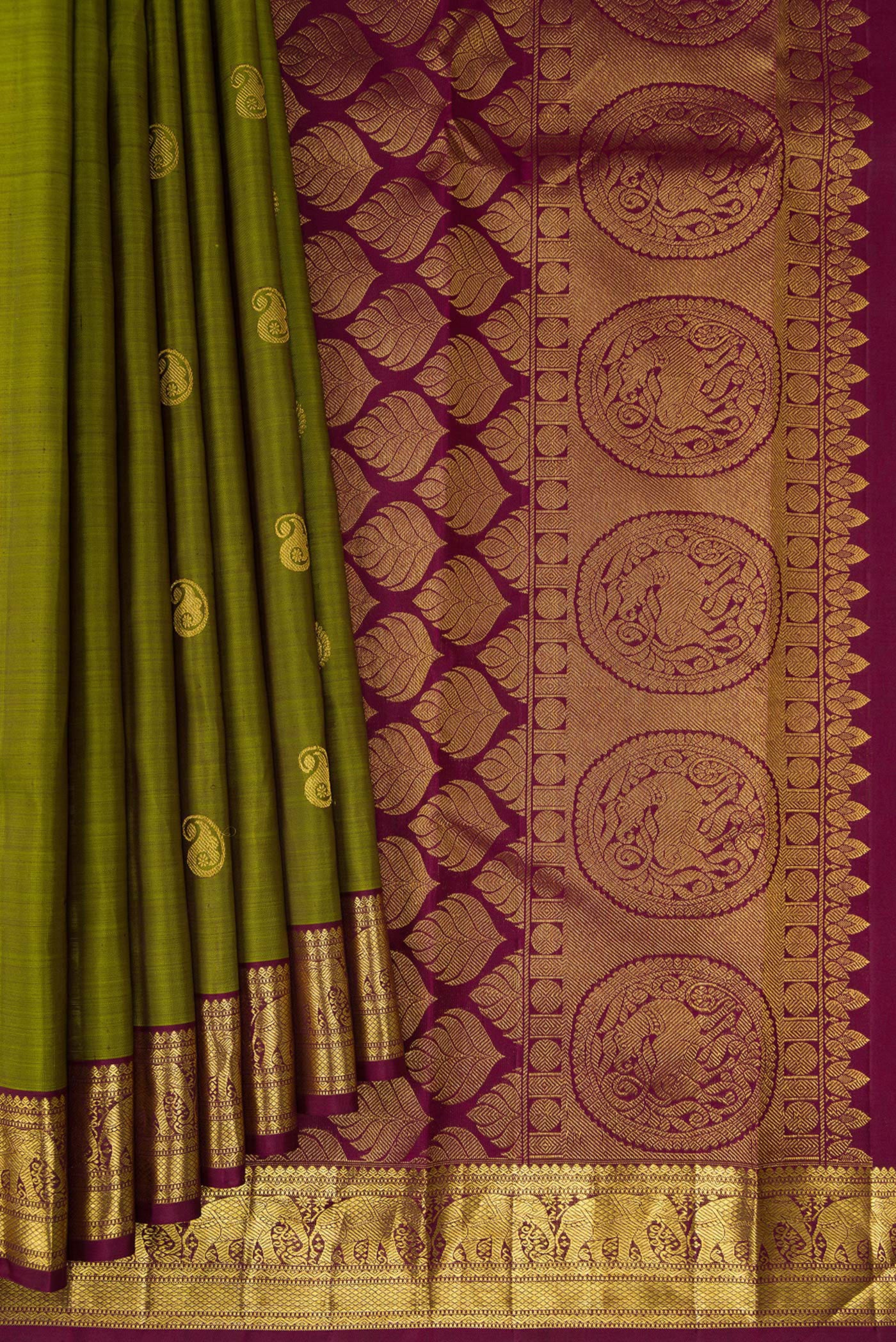 Pleats and pallu of Mehandi Green Kanchipuram Silk Saree with Zari Butta on the body and Zari Border. 
