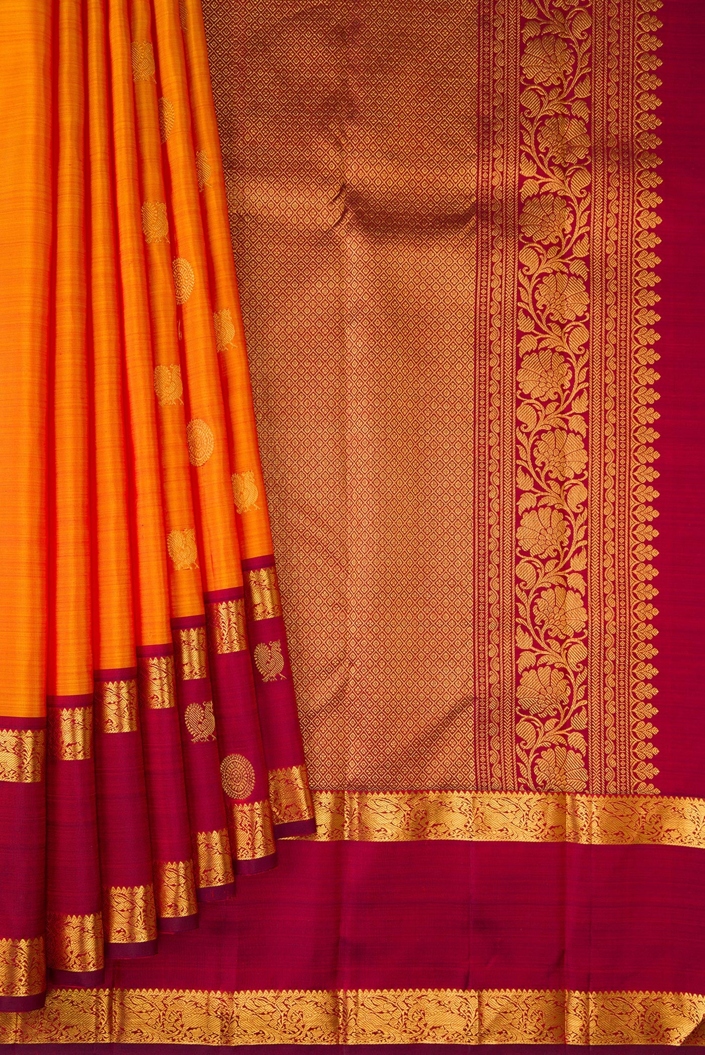 Pleats and pallu of Mustard Kanjivaram Silk Saree with Zari Butta on the body and Zari Border. 