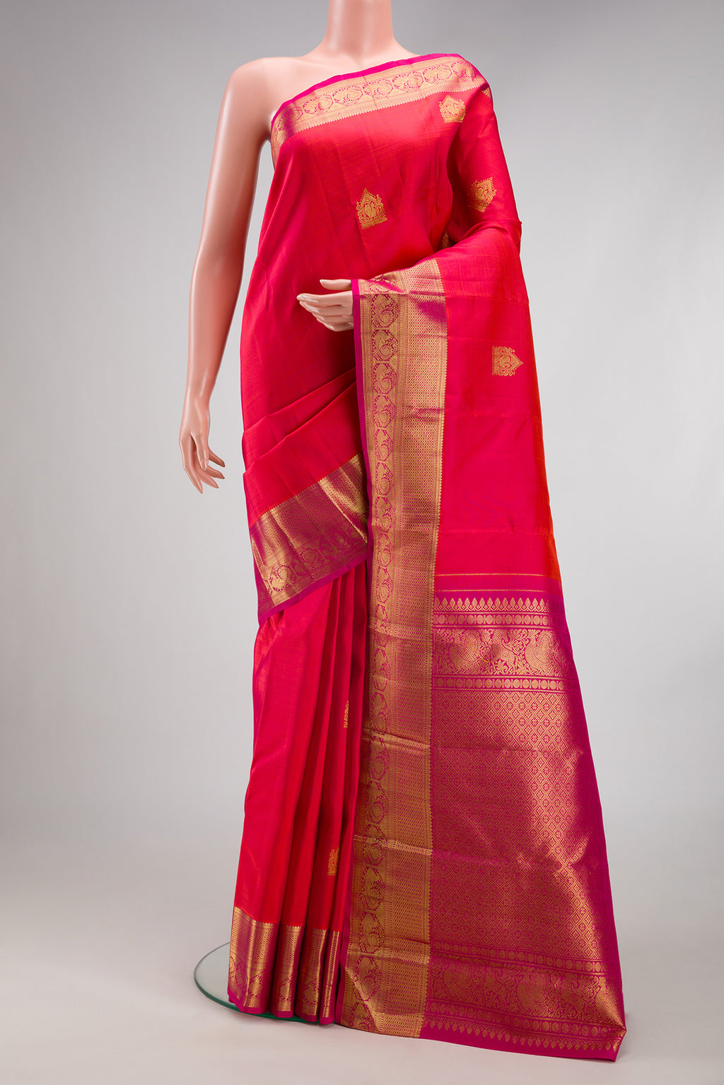 Dark Pink Dual Tone Kanjivaram Silk Saree with Zari Butta on the body and Zari Border.  displayed on a mannequin
