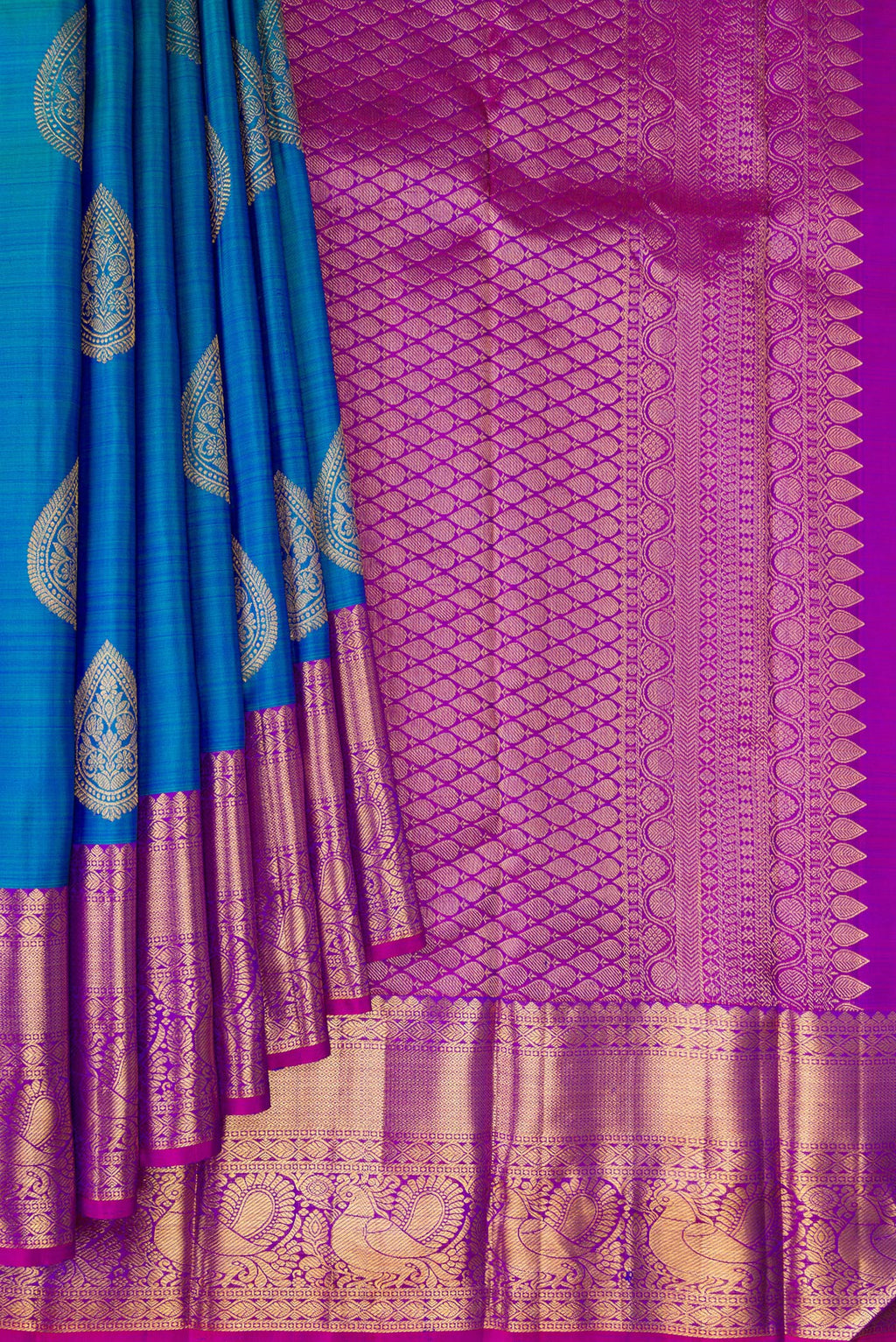 Pleats and pallu of Peacock Blue Kanjivaram Silk Saree with Zari Butta on the body and Fancy Border. 