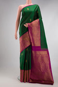 Bottle Green Kanjivaram Silk Saree with Zari Butta on the body and Fancy Border.  displayed on a mannequin
