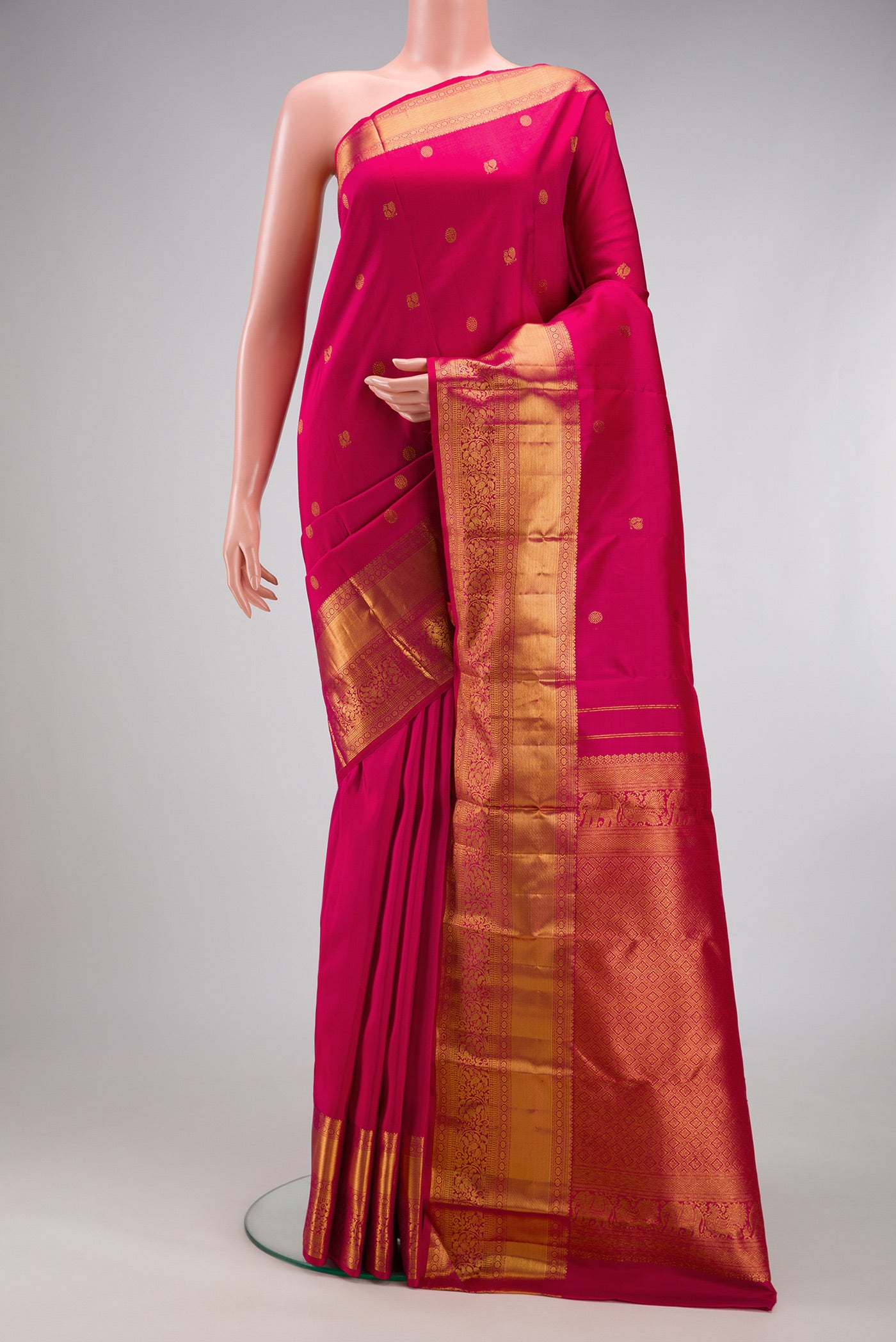 Dark Pink Kanjivaram Silk Saree with Zari Butta on the body and Zari Border.  displayed on a mannequin