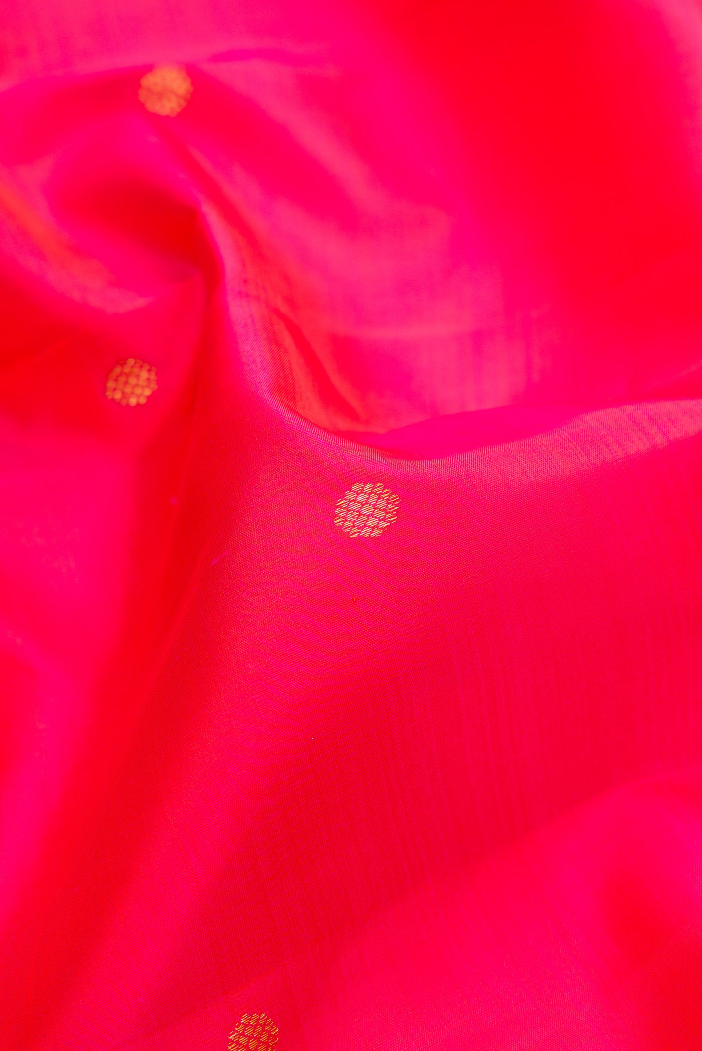 Close up of Pink Kanjivaram Silk Saree with Zari Butta on the body and Zari Border.  displaying folds